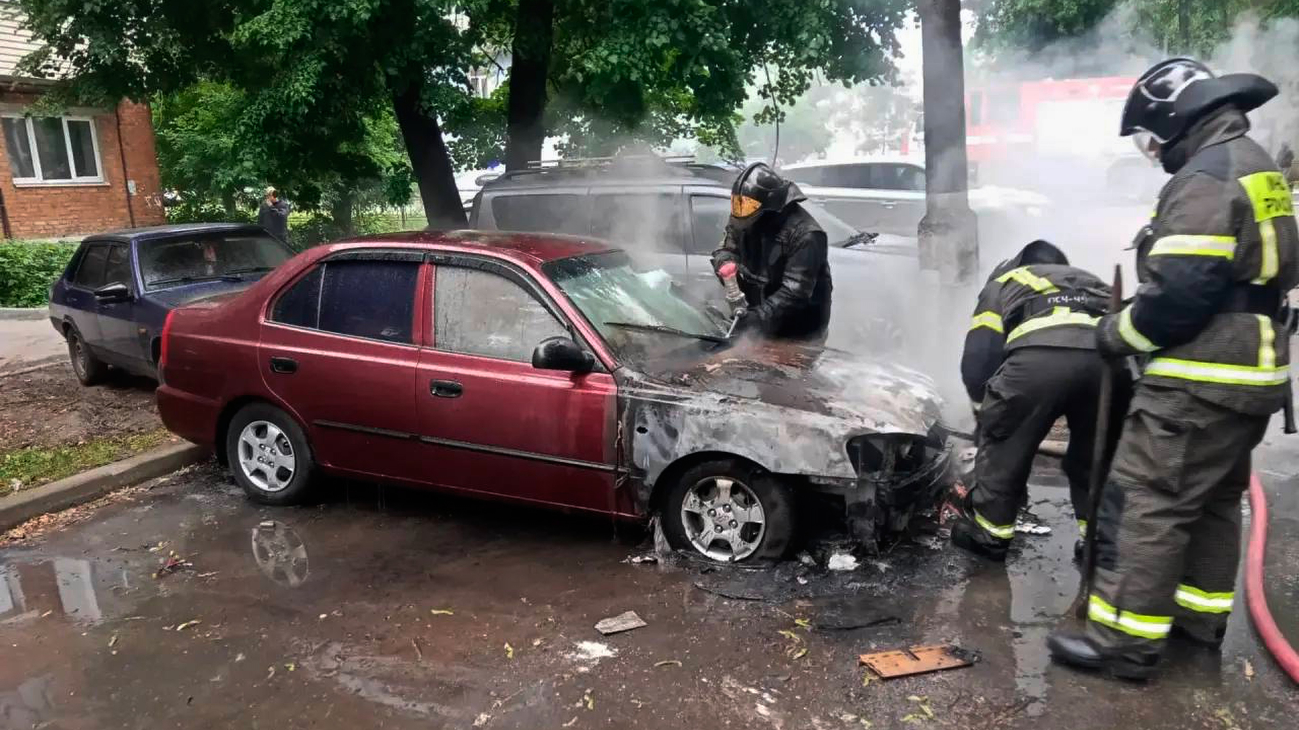 This photo provided by Moscow Region Governor Andrei Vorobyev's official telegram channel shows firefighters extinguish a burning car after a Ukrainian drone attack.