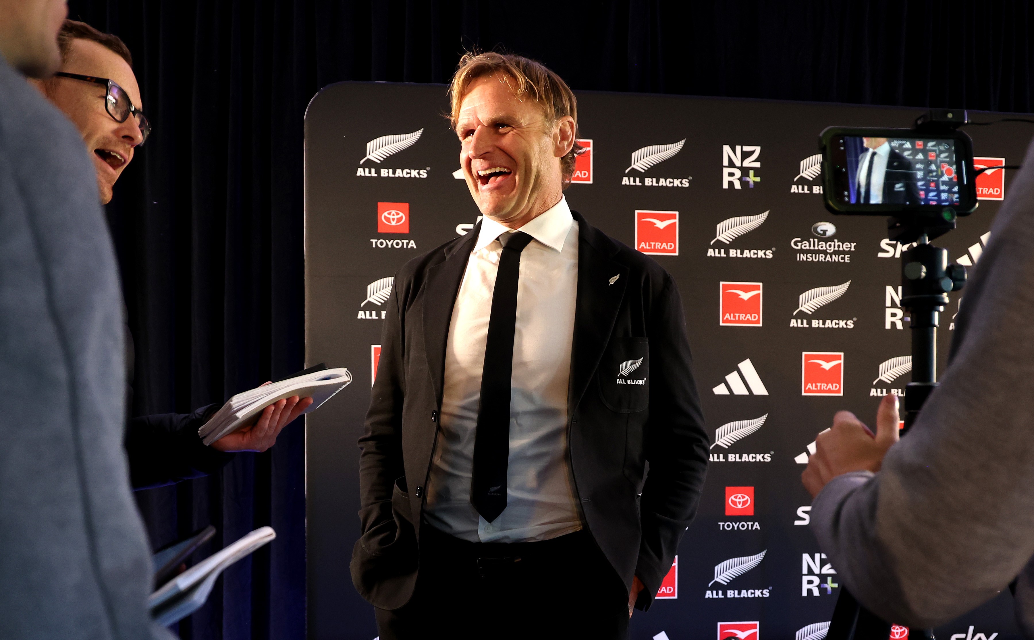 Scott Robertson jokes with members of the media at today's All Blacks squad announcement at the Coastal Rugby Club.