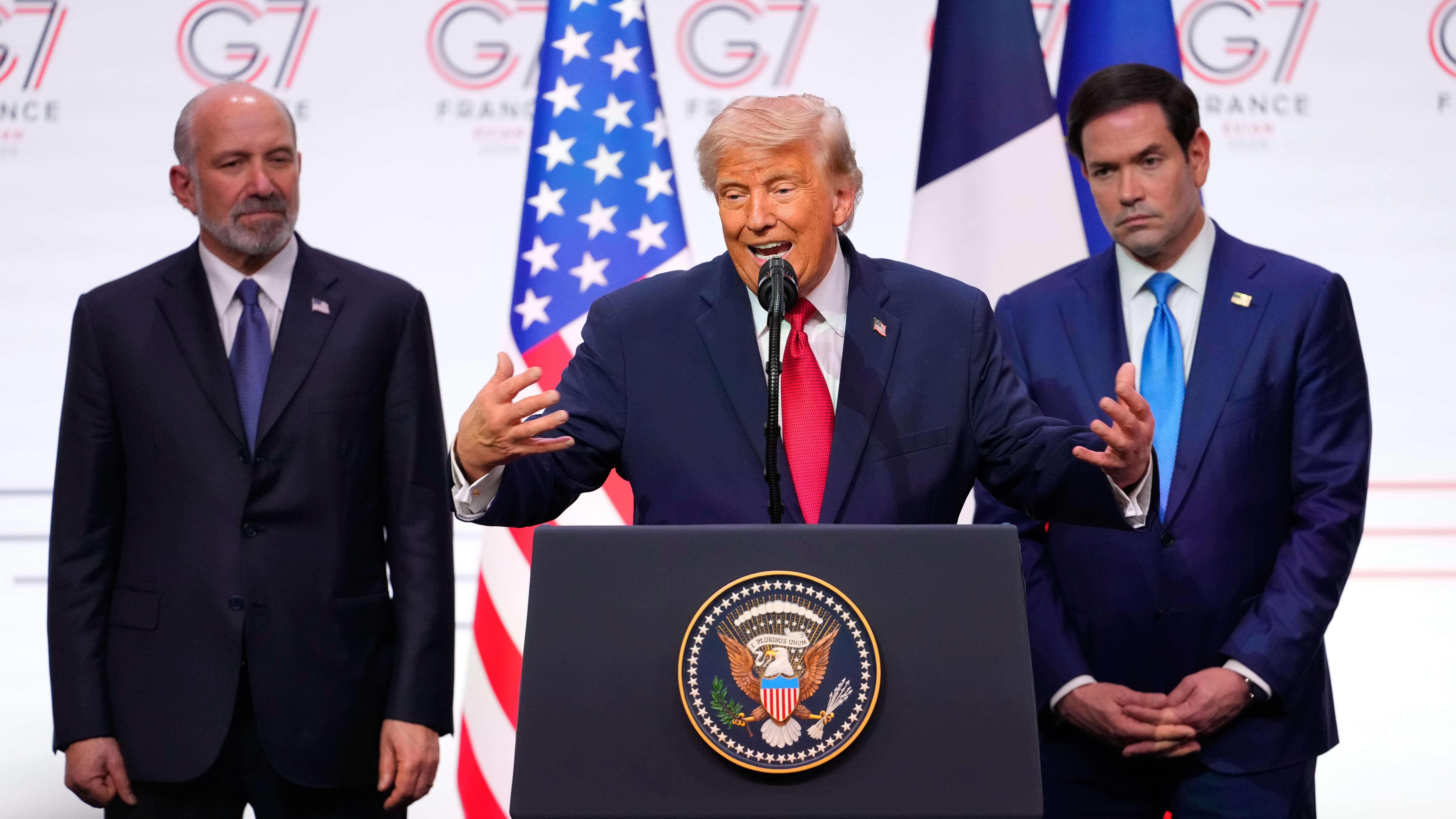 US President Donald Trump, centre, speaks as he is flanked by, US Secretary of Commerce Howard Lutnick, left, and United States Secretary of State Marco Rubio during a media conference at the end of the G7 summit.