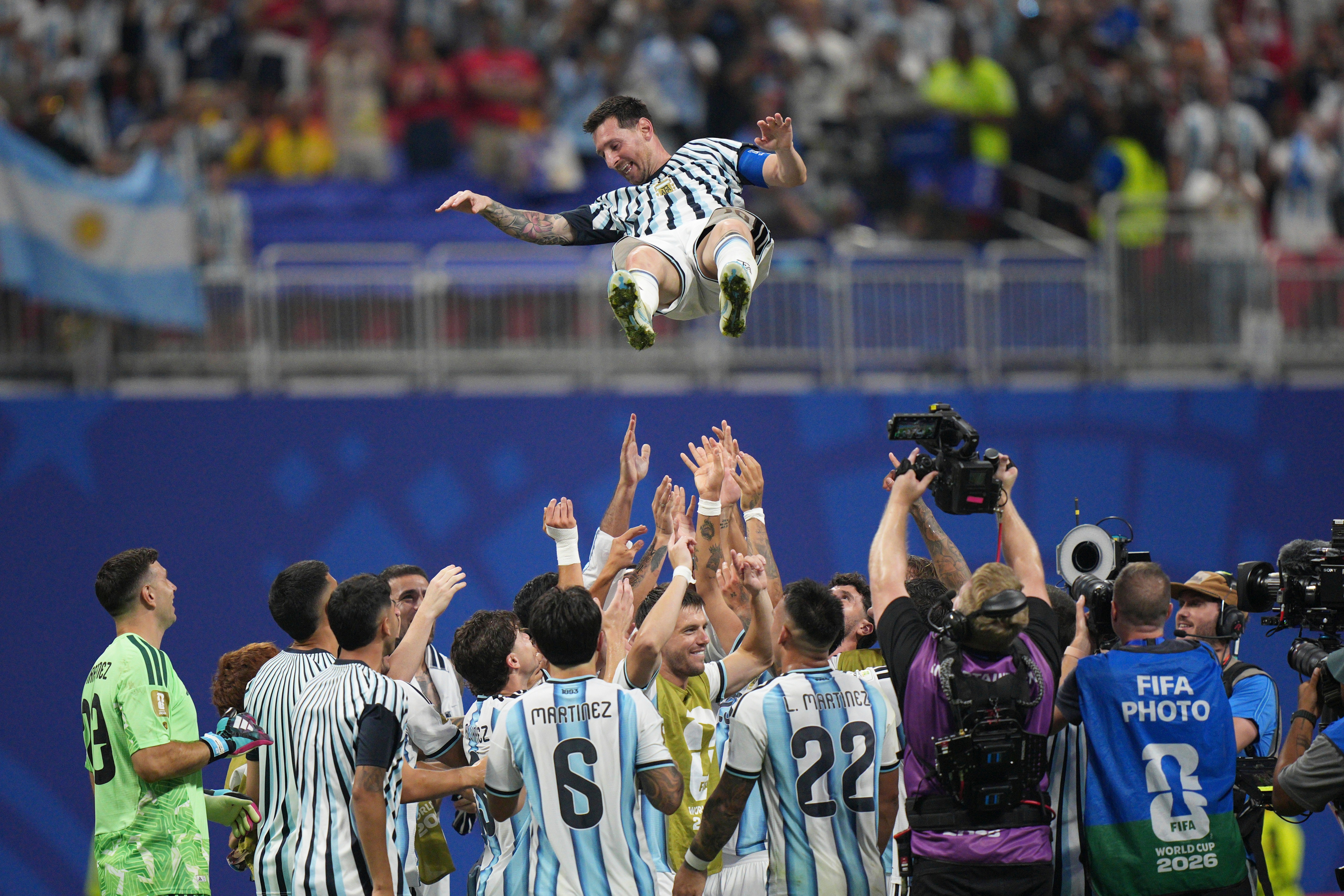 Messi is tossed into the air by his teammates after win over Egypt.