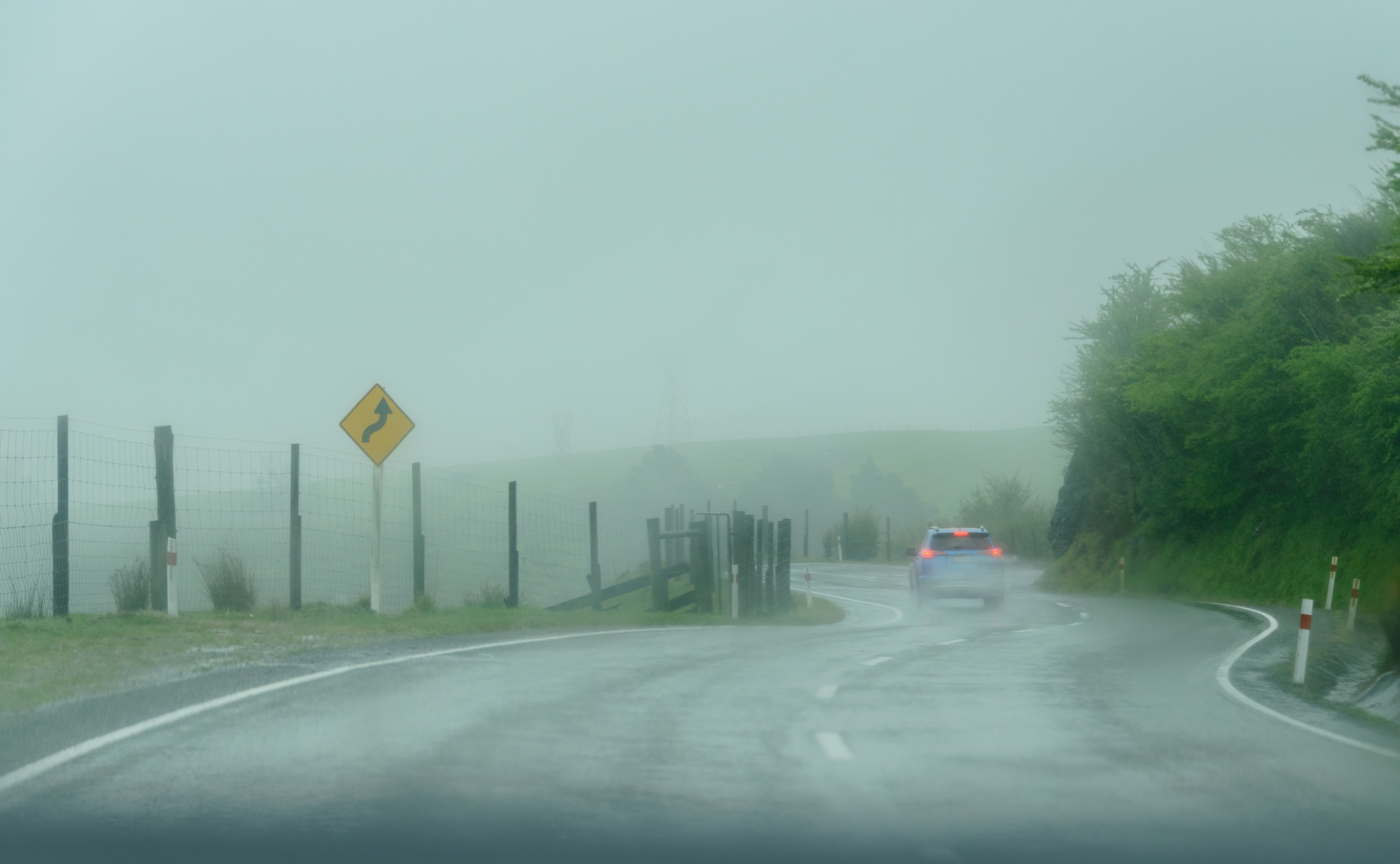 A car drives in a storm, Golden bay.