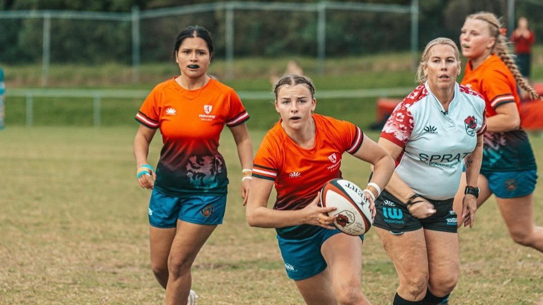 Rebecca Stanaway referees a rugby game. 