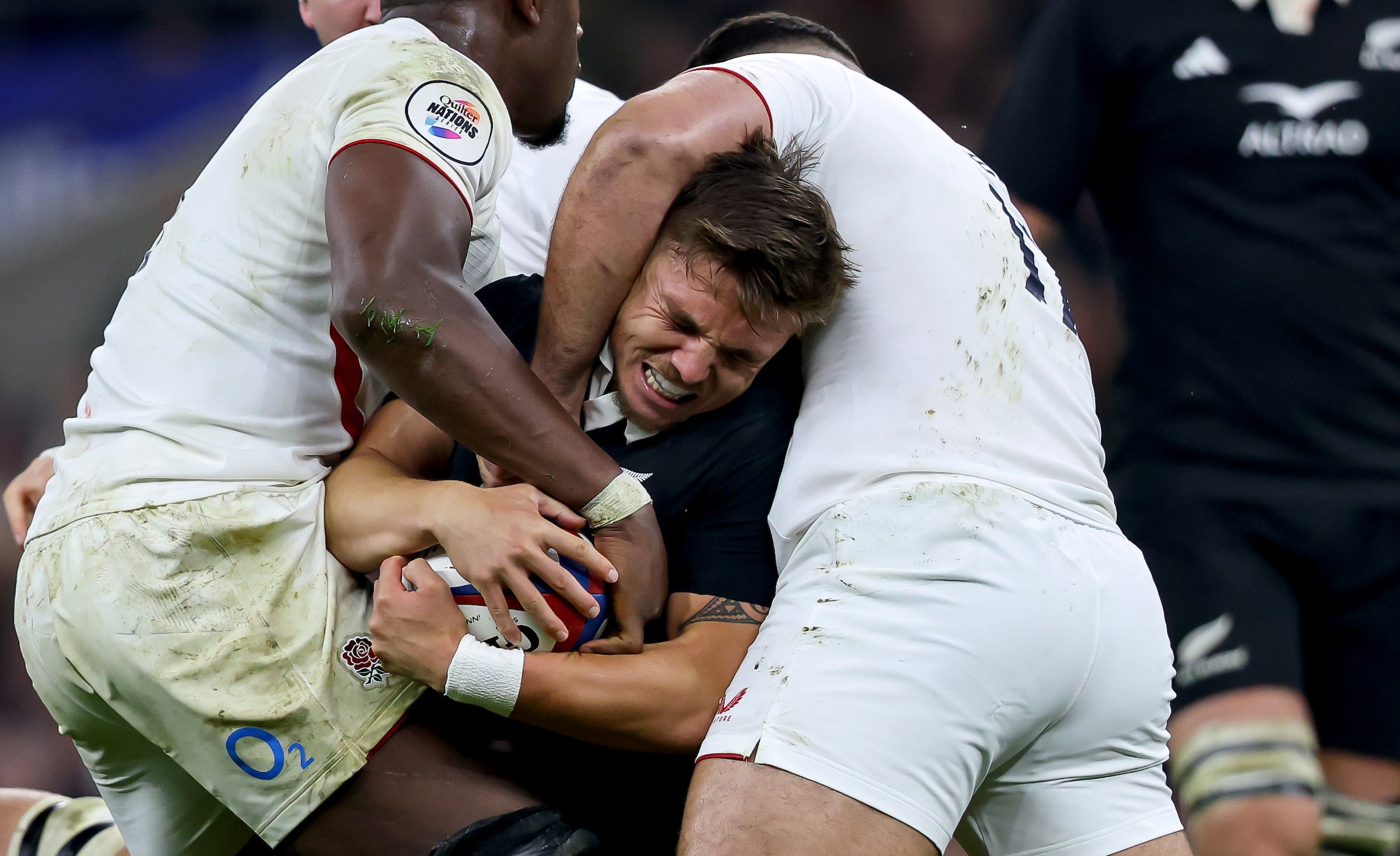 Cortez Ratima is tackled by England's Maro Itoje, left, and Ellis Genge at Twickenham.