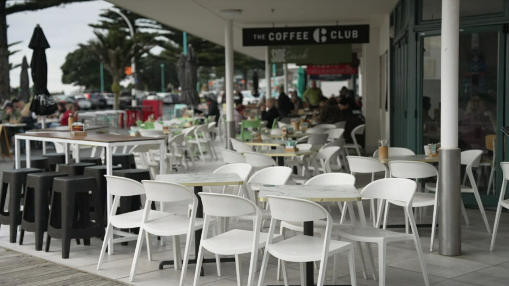 Empty seats outside a Mount Maunganui cafe, as ongoing landslip closures keep foot traffic away from the strip below Mauao.
