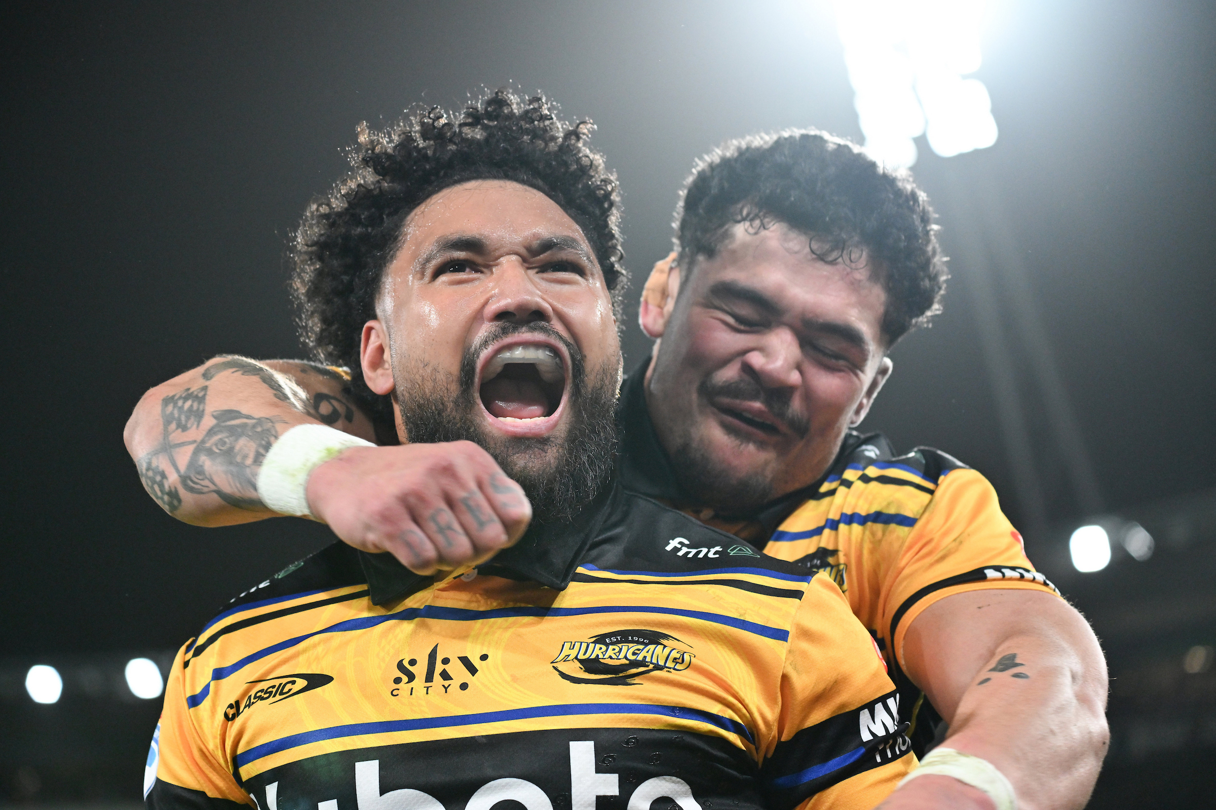 Fehi Fineanganofo, left, celebrates his try against the Chiefs with Hurricanes skipper Du'Plessis Kirifi.