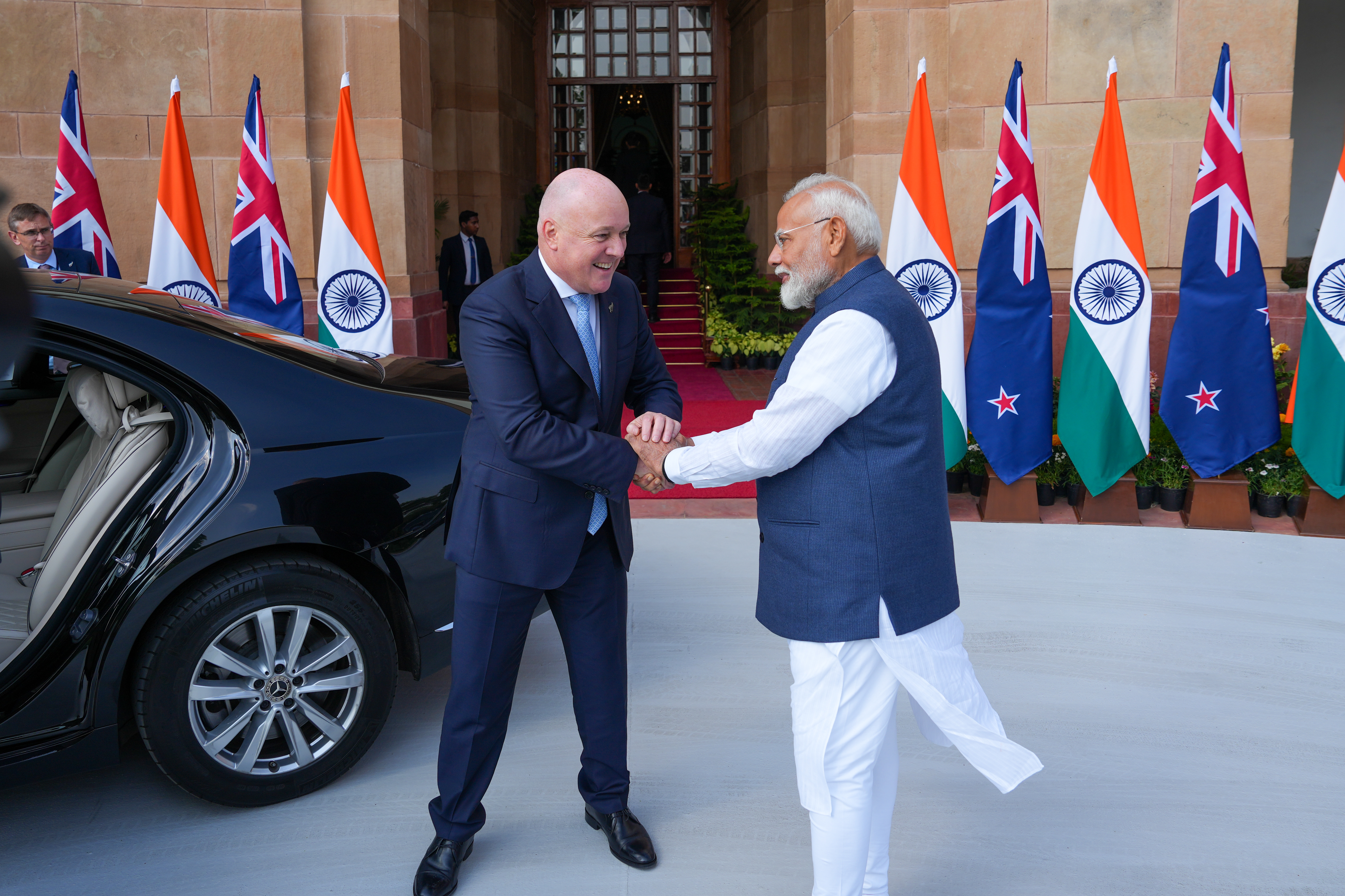 New Zealand Prime Minister Christopher Luxon and India Prime Minister Narendra Modi shake hands in India in March 2025 when negotiations were launched. 