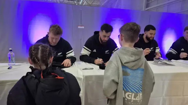 All Blacks fans line up in Christchurch to get things signed by the players.