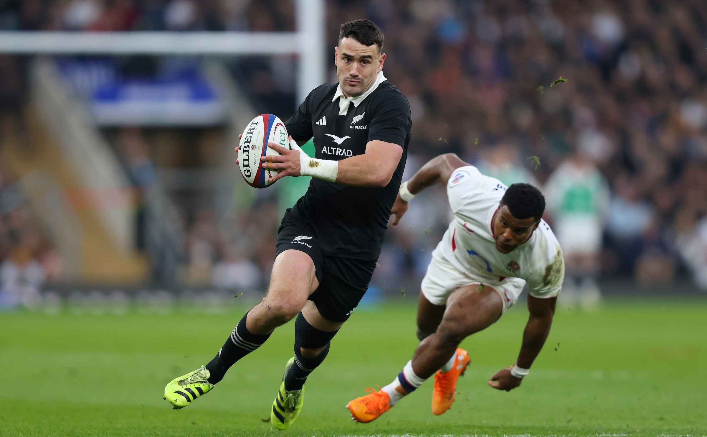 All Blacks fullback Will Jordan gets on the outside of England wing Immanuel Feyi-Waboso.