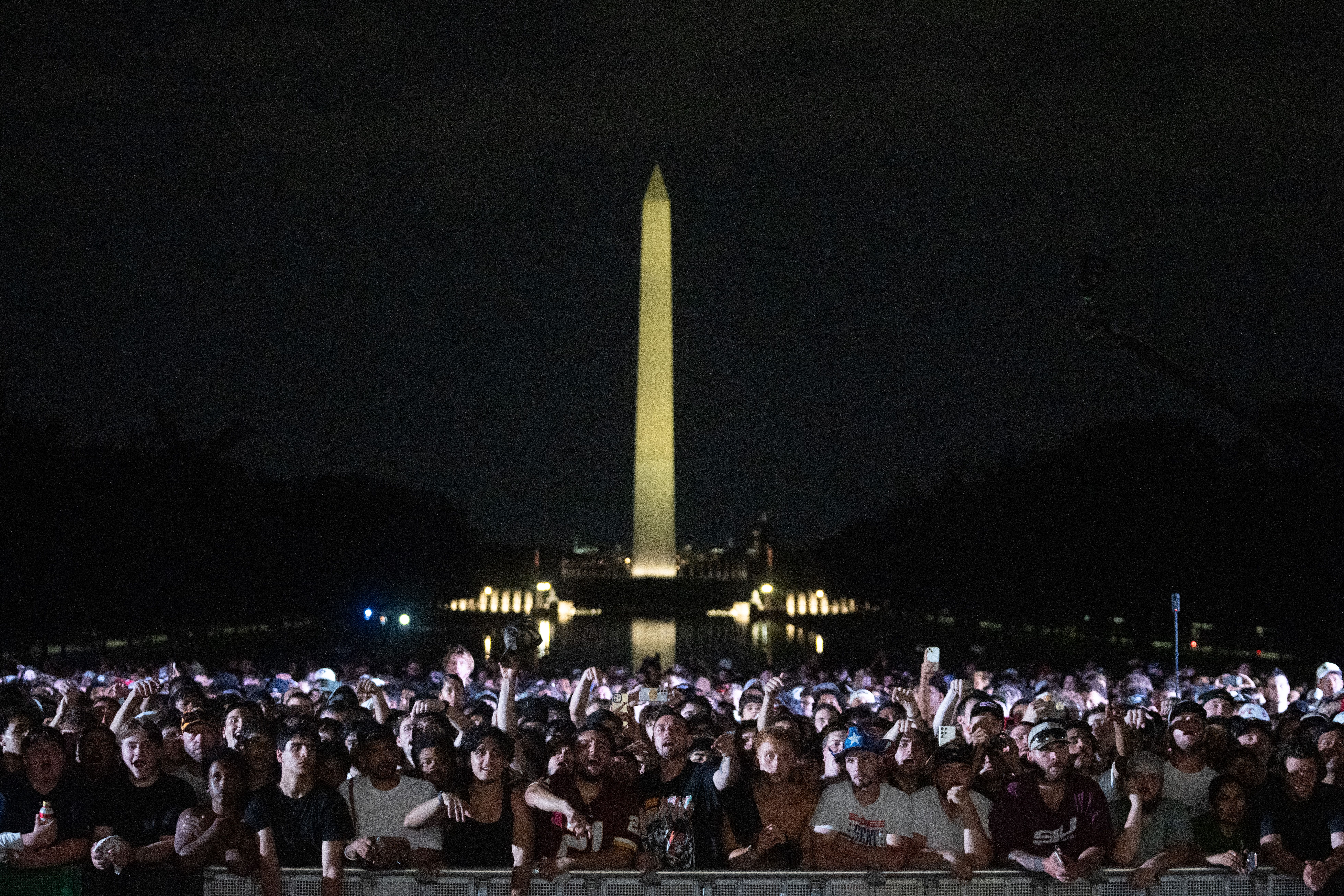 Audience members cheer and boo during a UFC news conference at the Lincoln Memorial, ahead of Sunday's fight on the South Lawn of the White House