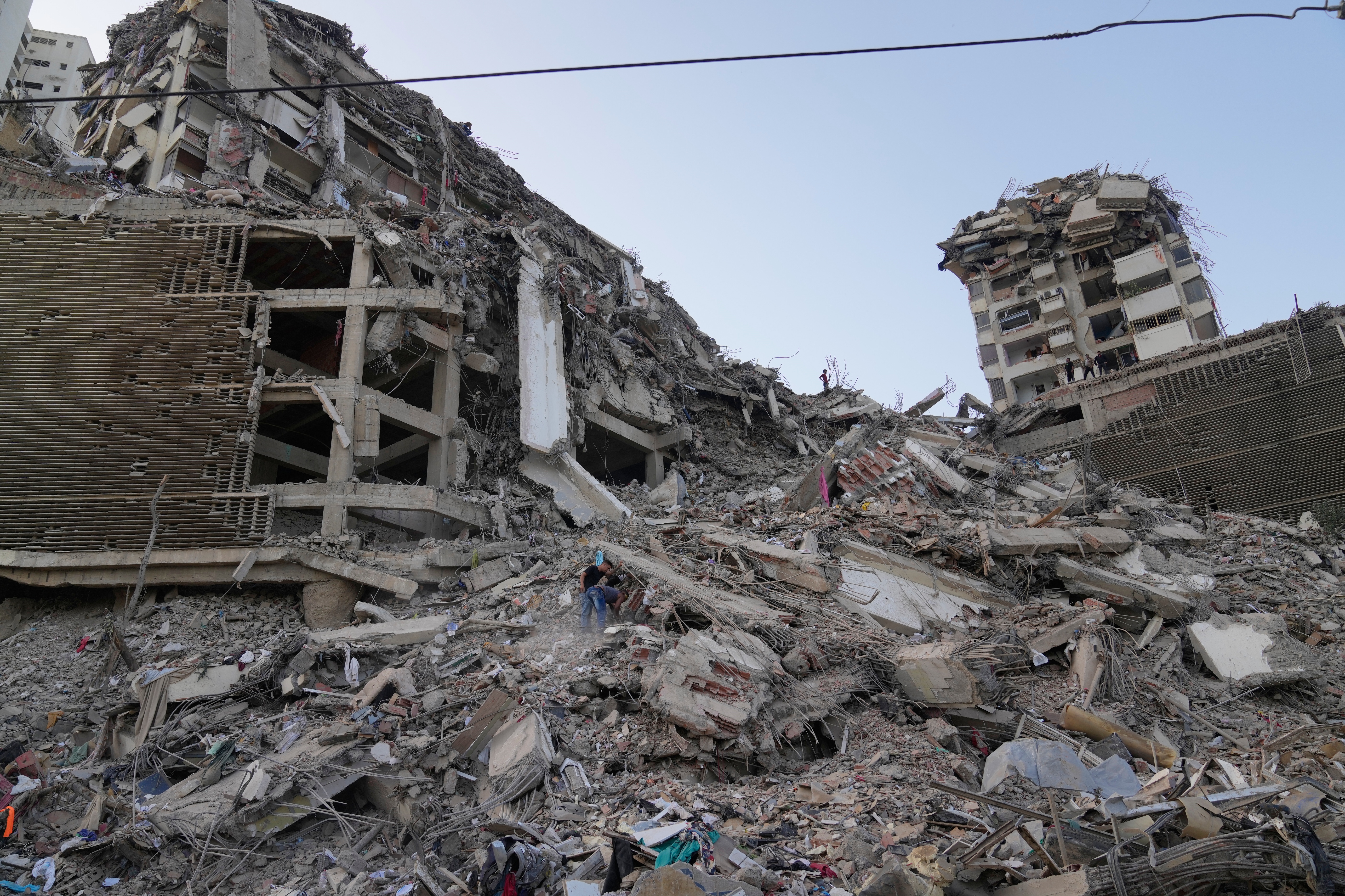 Residents search through the rubble two days after an earthquake struck La Guaira, Venezuela