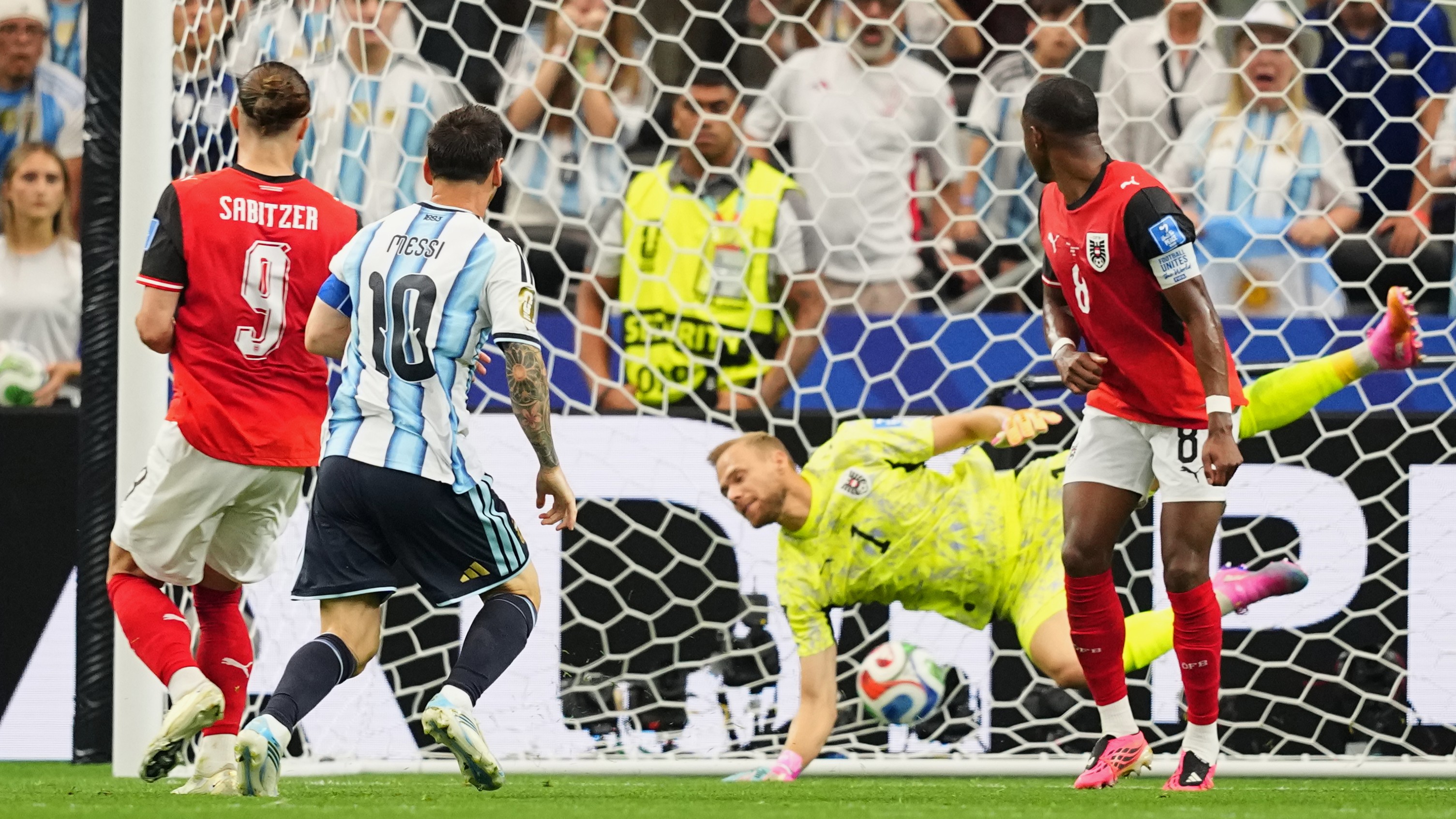 Argentina's Lionel Messi, center, scores the opening goal during the World Cup Group J soccer match between Argentina and Austria in Arlington, Texas, near Dallas.