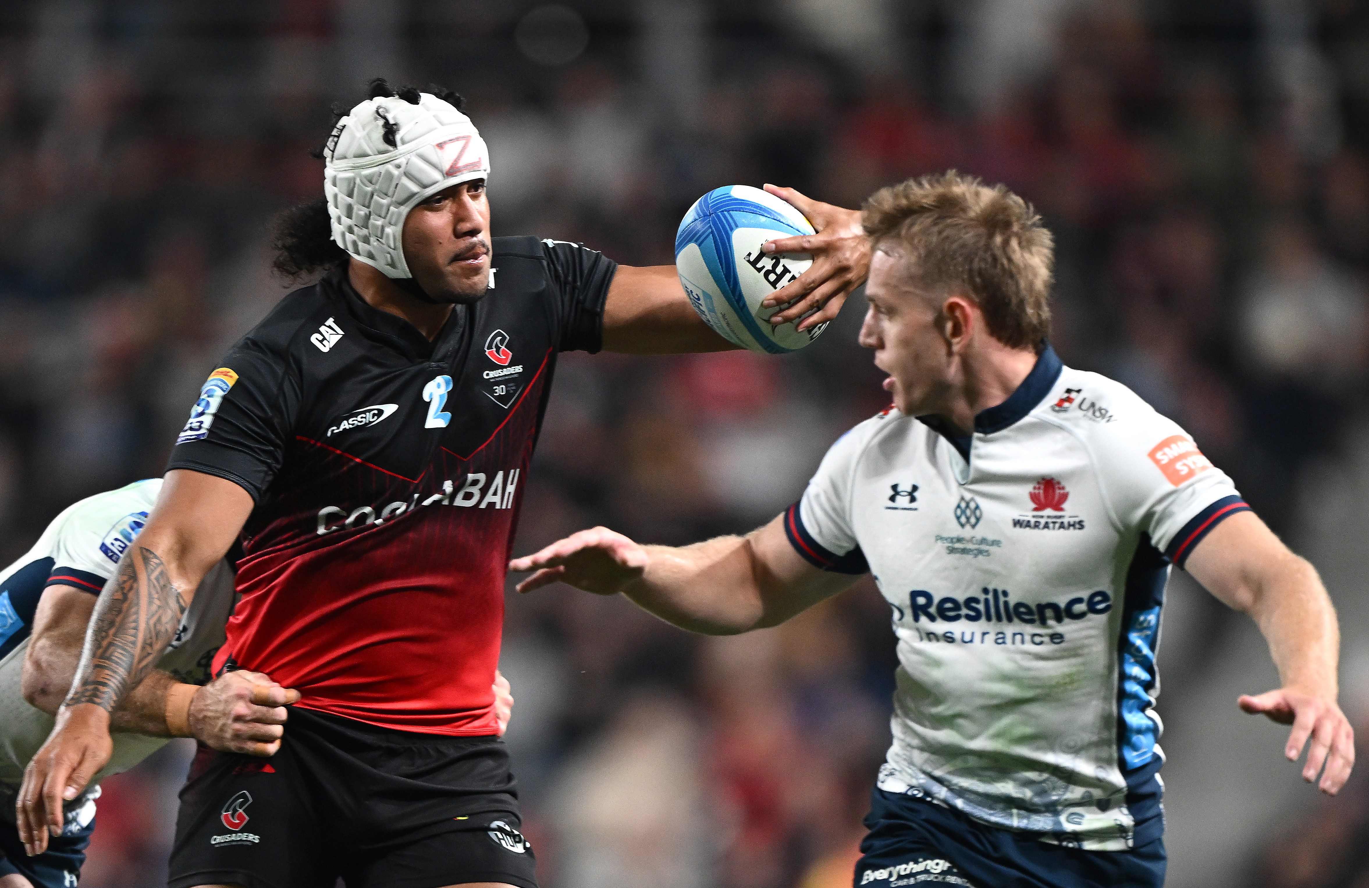 Crusaders loose forward Leicester Fainga'anuku creates havoc against the Waratahs.