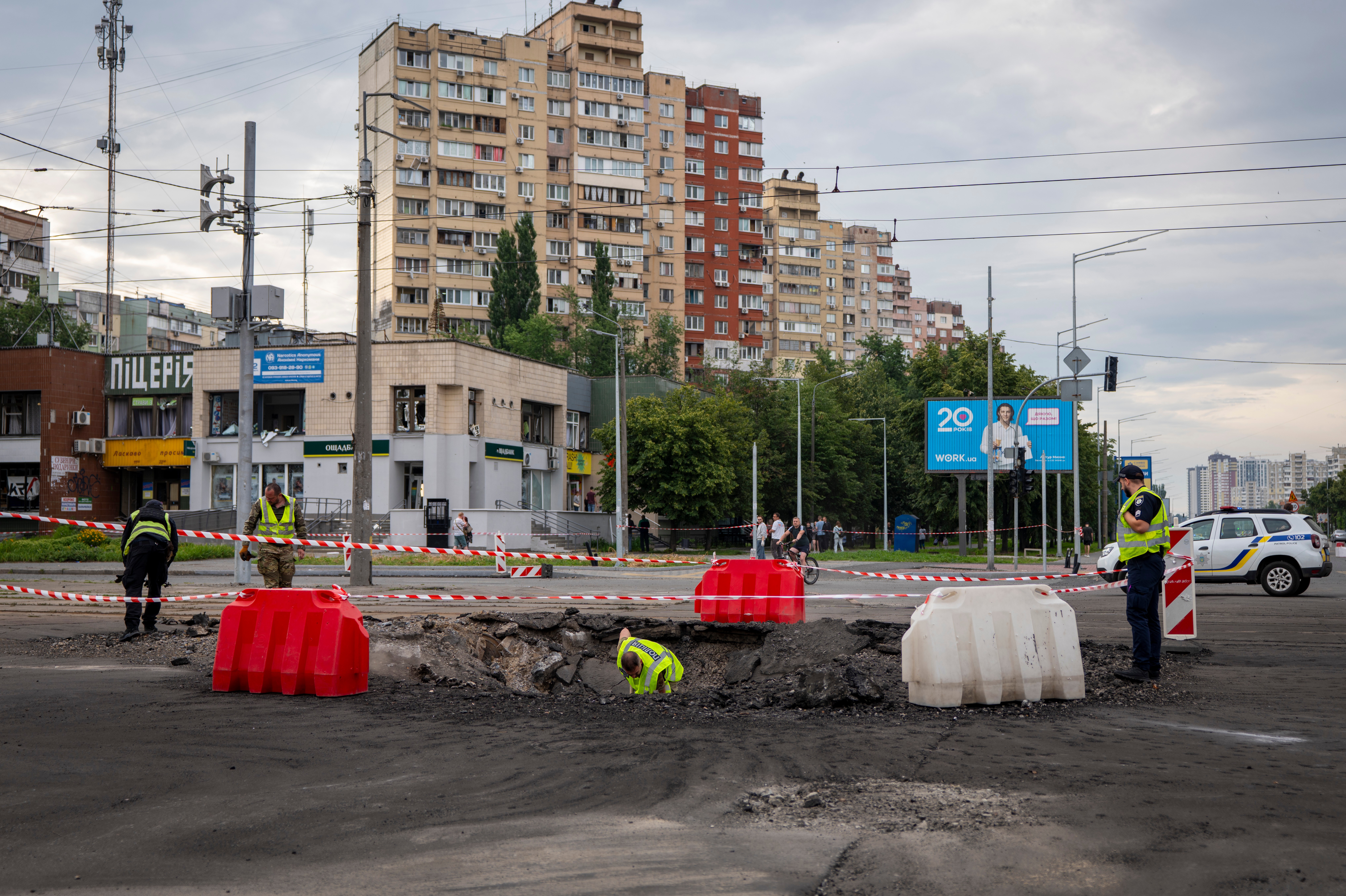 A sapper examines the impact site of a Russian missile in a residential area of Kyiv, Saturday, July 11, 2026. 