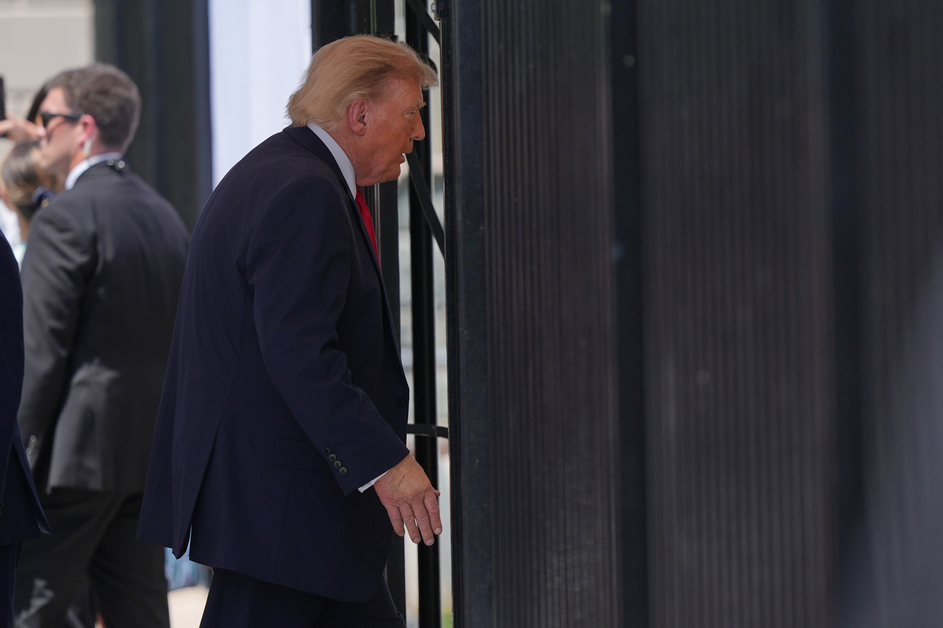 President Donald Trump departs after speaking at an event to promote the Freedom 250 Grand Prix IndyCar race in August, Monday, July 13, 2026, on West Executive Drive at the White House in Washington.