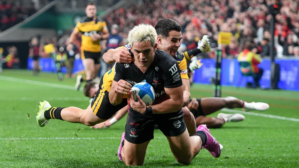 Noah Hotham of the Crusaders scores a try in the tackle of Josh Moorby.