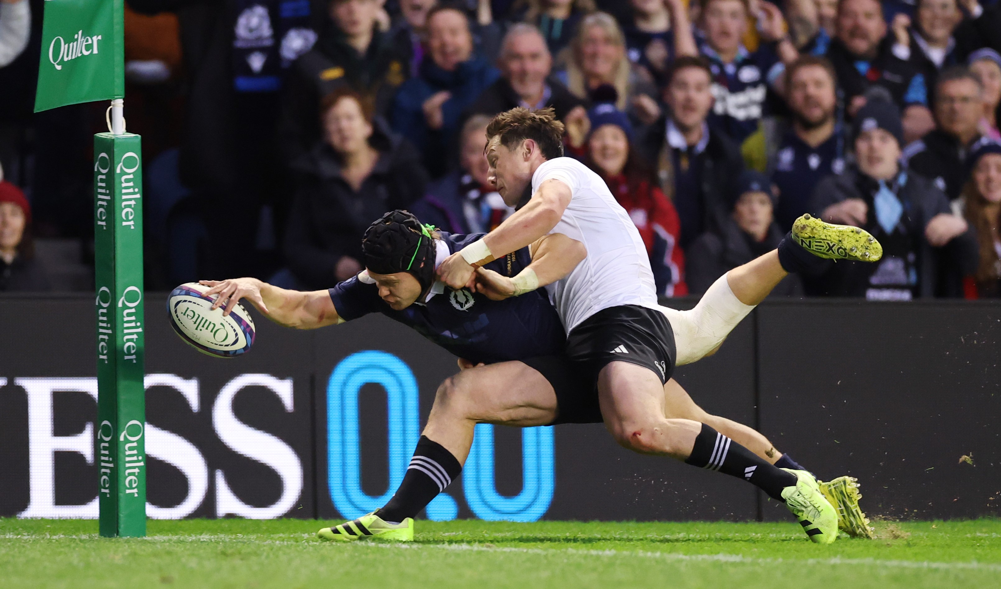 Cam Roigard makes a try-saving tackle on Scotland wing Darcy Graham.