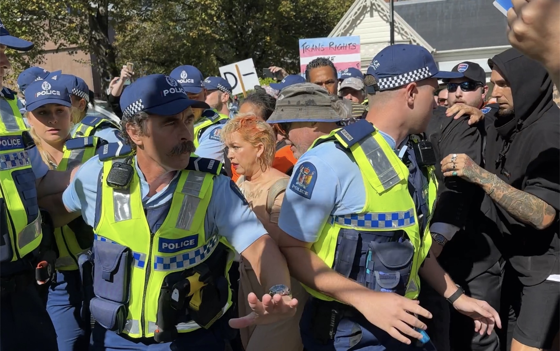 Posie Parker escorted from Albert Park by police.