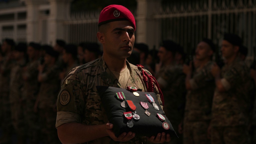 A Lebanese Army soldier carries the medals of Lebanese Brig. Gen. Wissam Sabra during his funeral procession in Beirut, Lebanon.