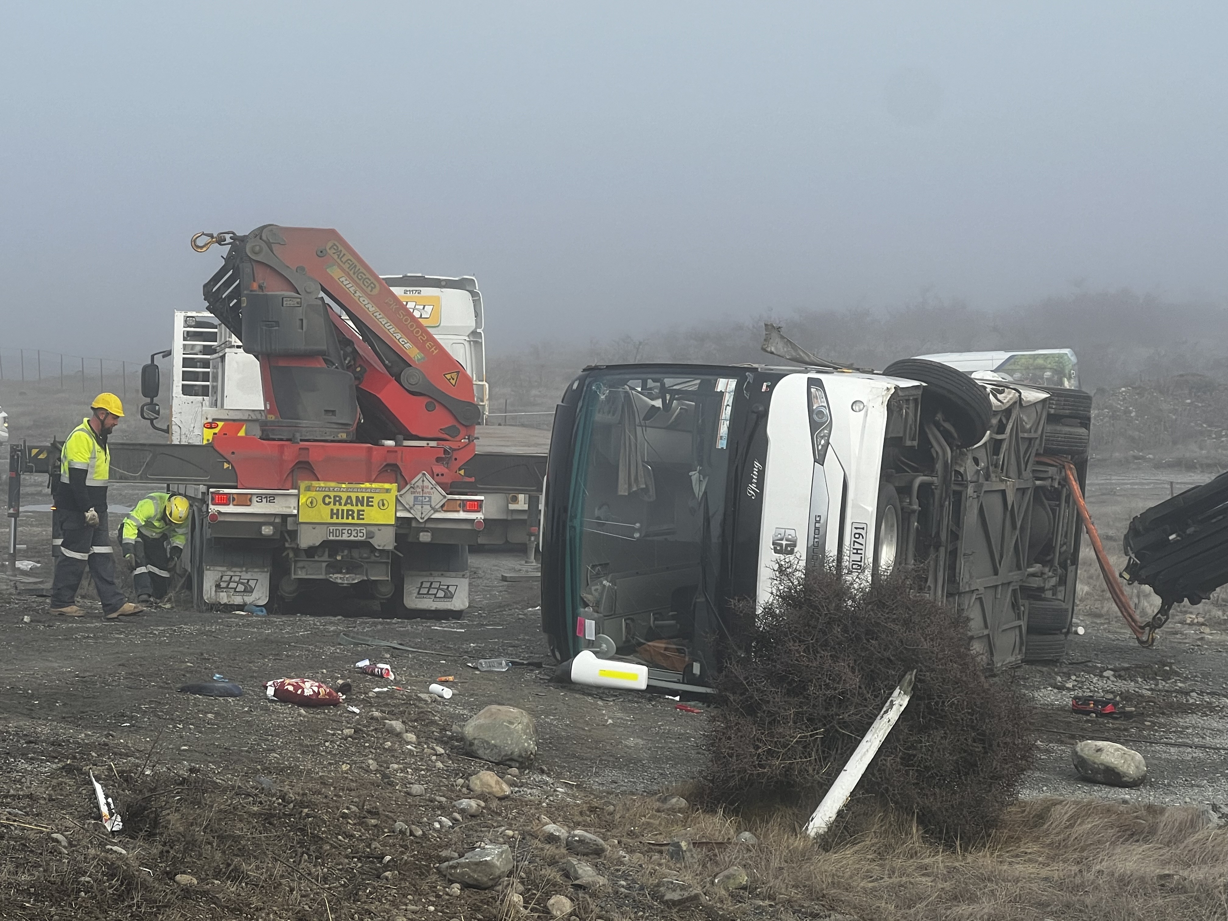 Recovery crews prepare to remove one of the crashed buses 
