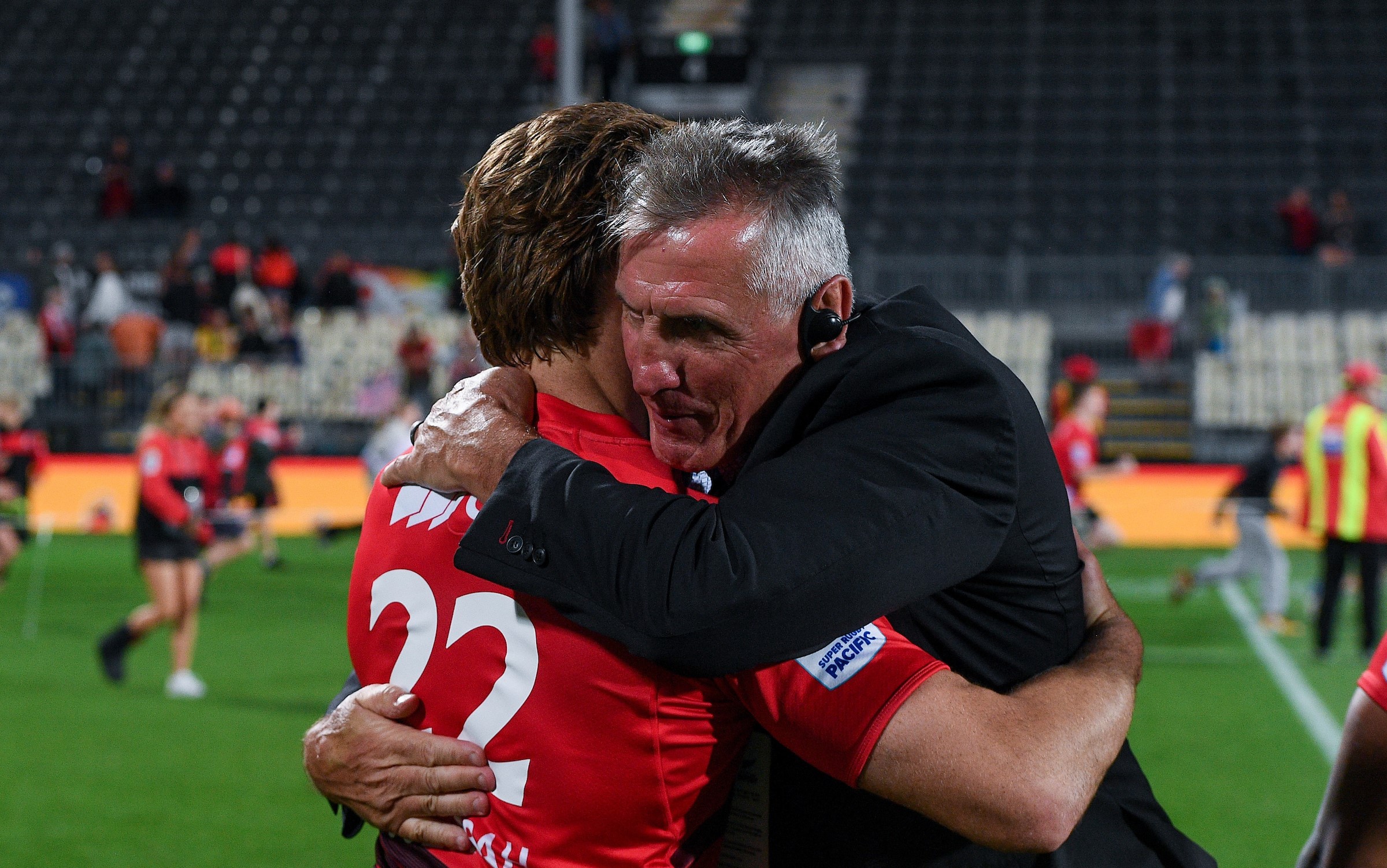 Crusaders head coach Rob Penney hugs first-five James O'Connor after his team's round one win over the Hurricanes.