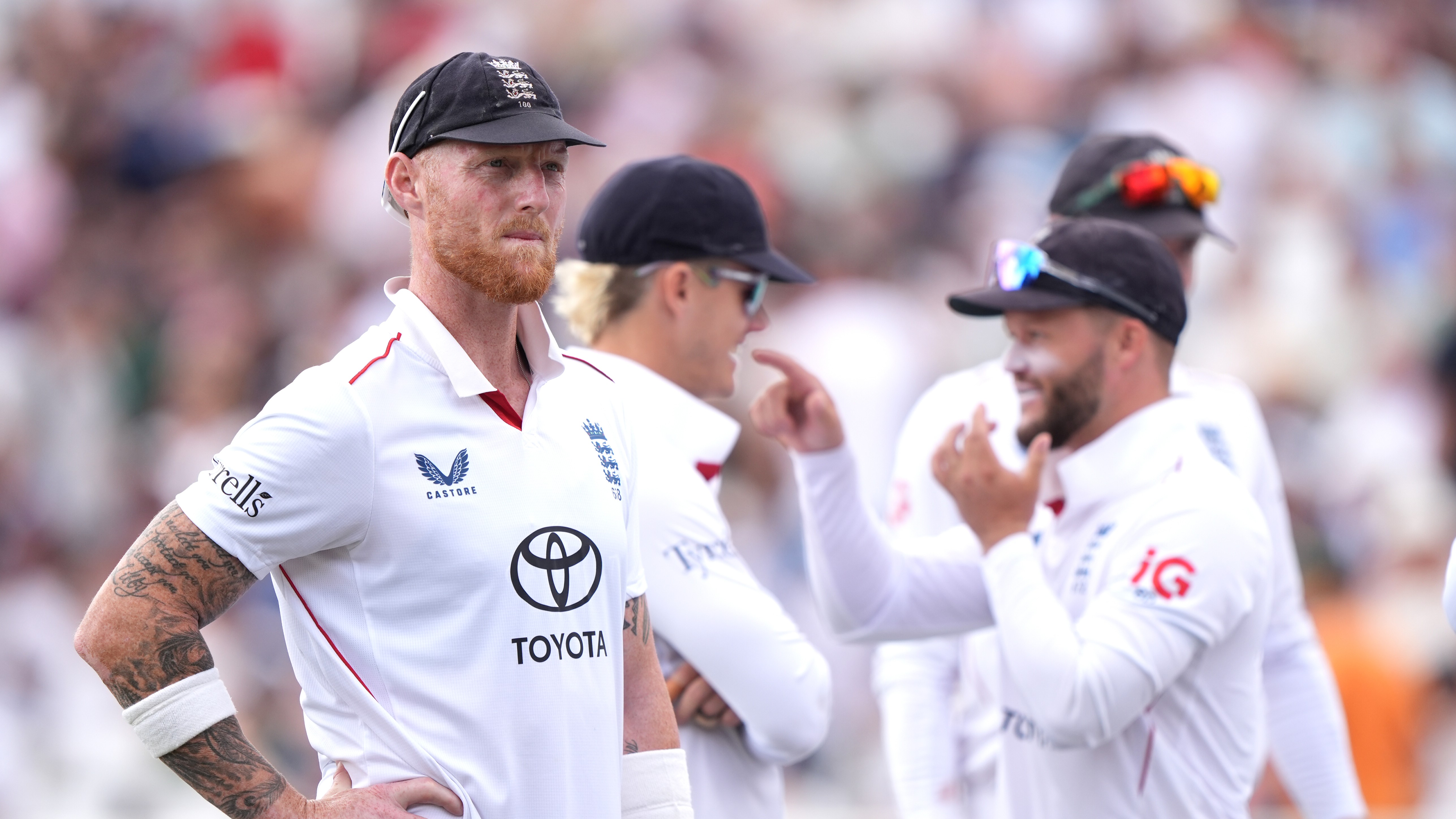 England's Ben Stokes, left looks on with teammates on day four of the Third Test cricket match between England and New Zealand, in Nottingham, England.