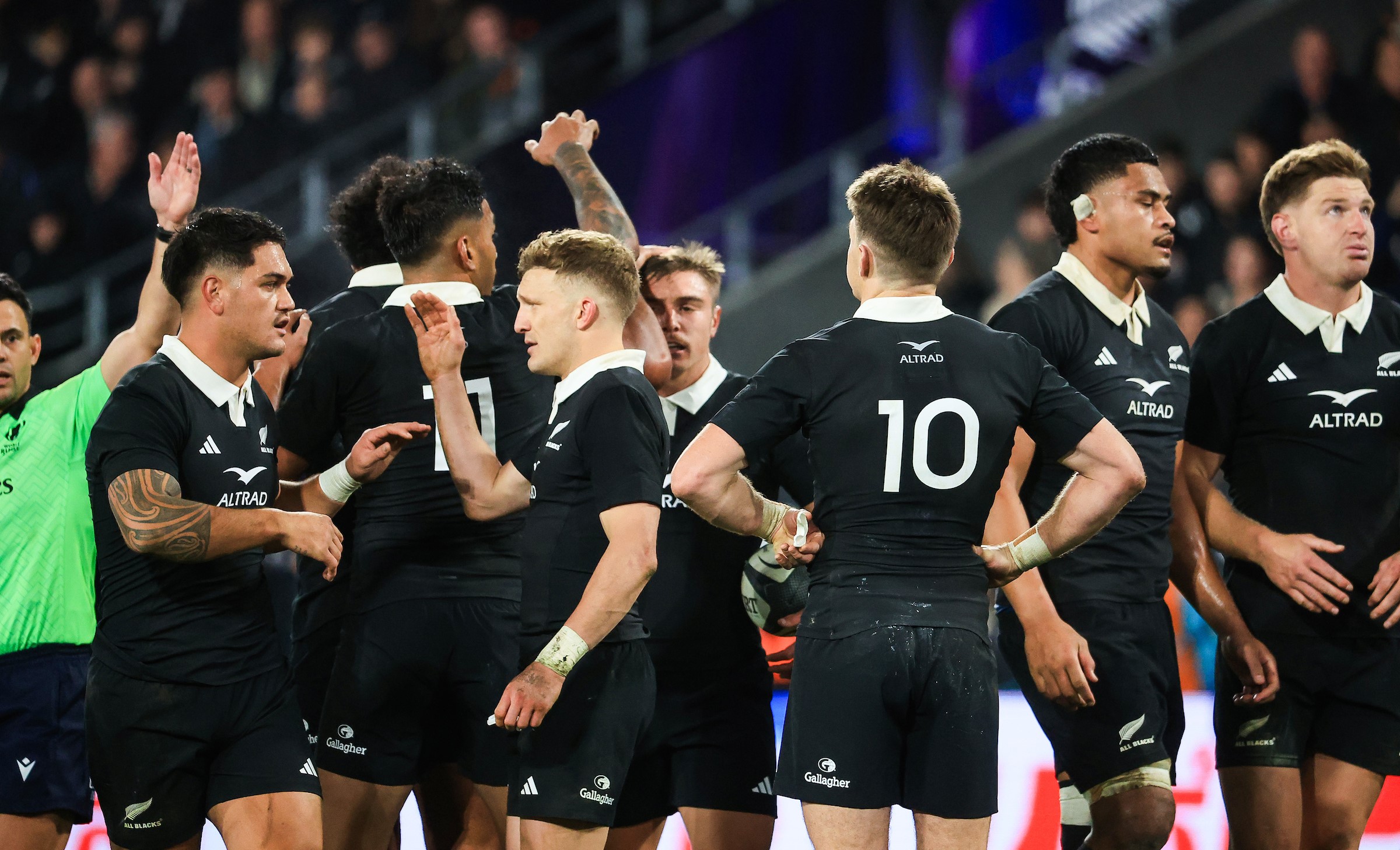 The relieved All Blacks celebrate the win over France in Dunedin.