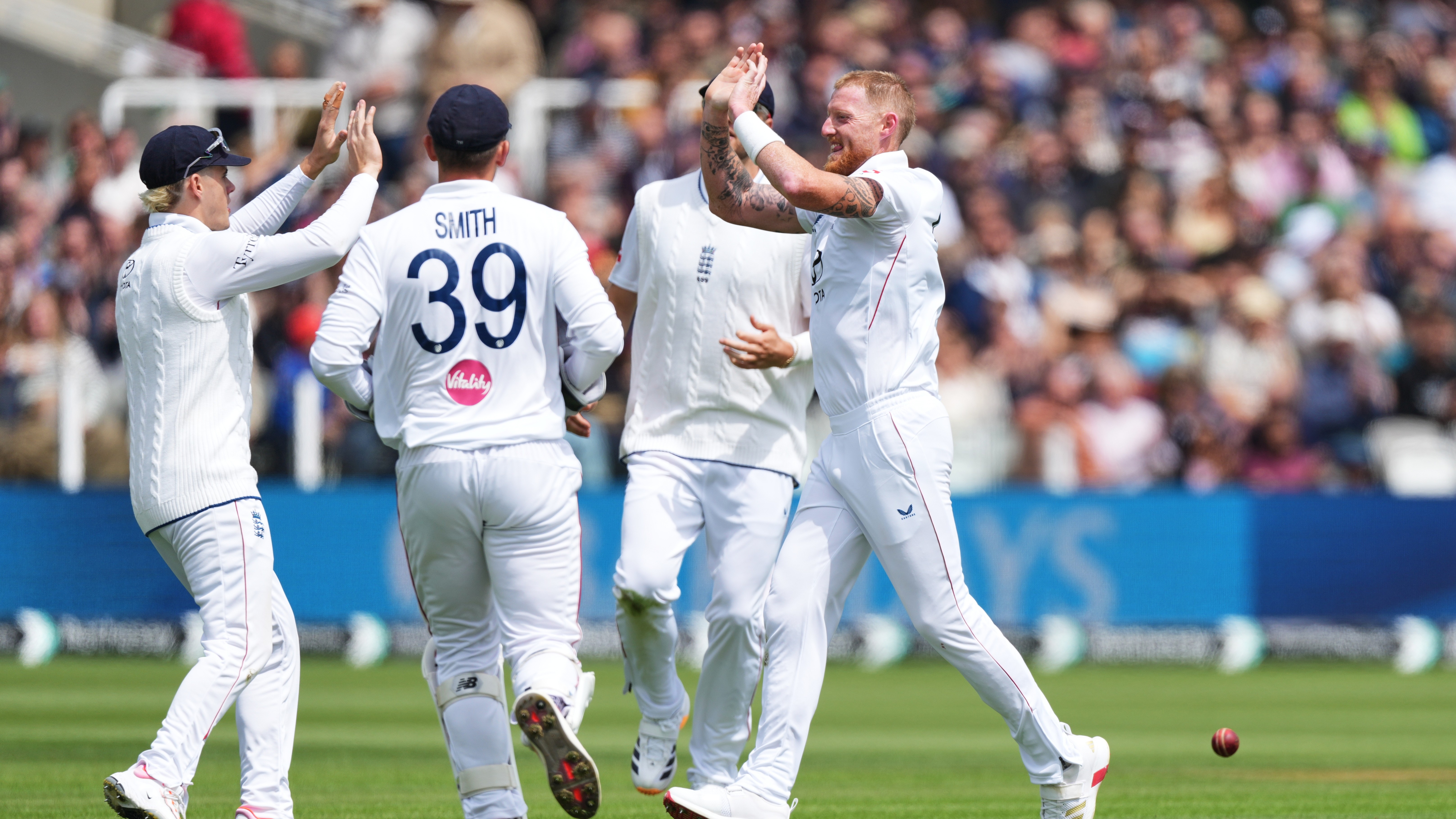 England's captain Ben Stokes, right, celebrates with teammates after the dismissal of New Zealand's Devon Conway during the fourth day.