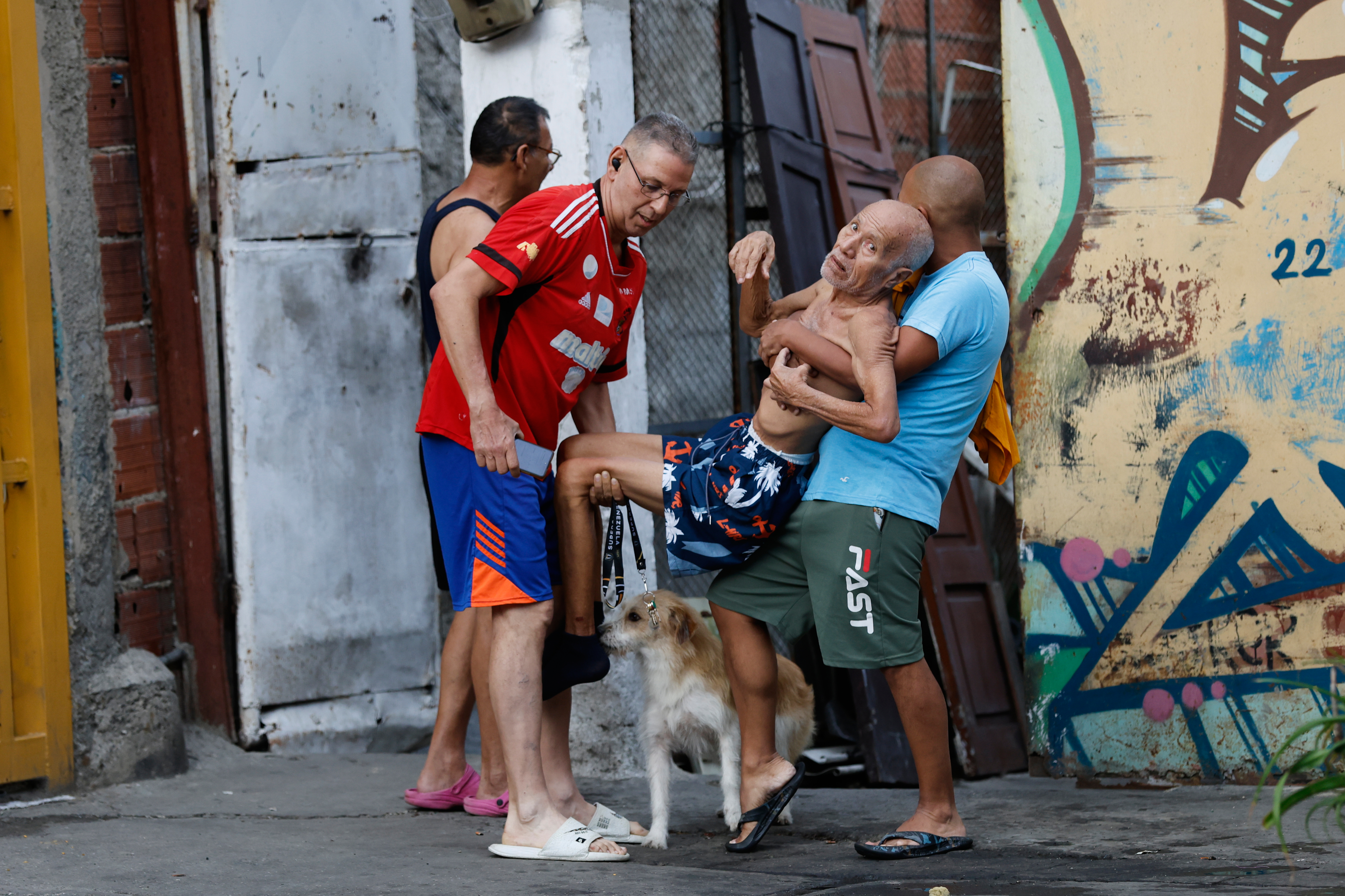 Neighbours helps a man evacuate his damaged home after an earthquake in Caracas, Venezuela.