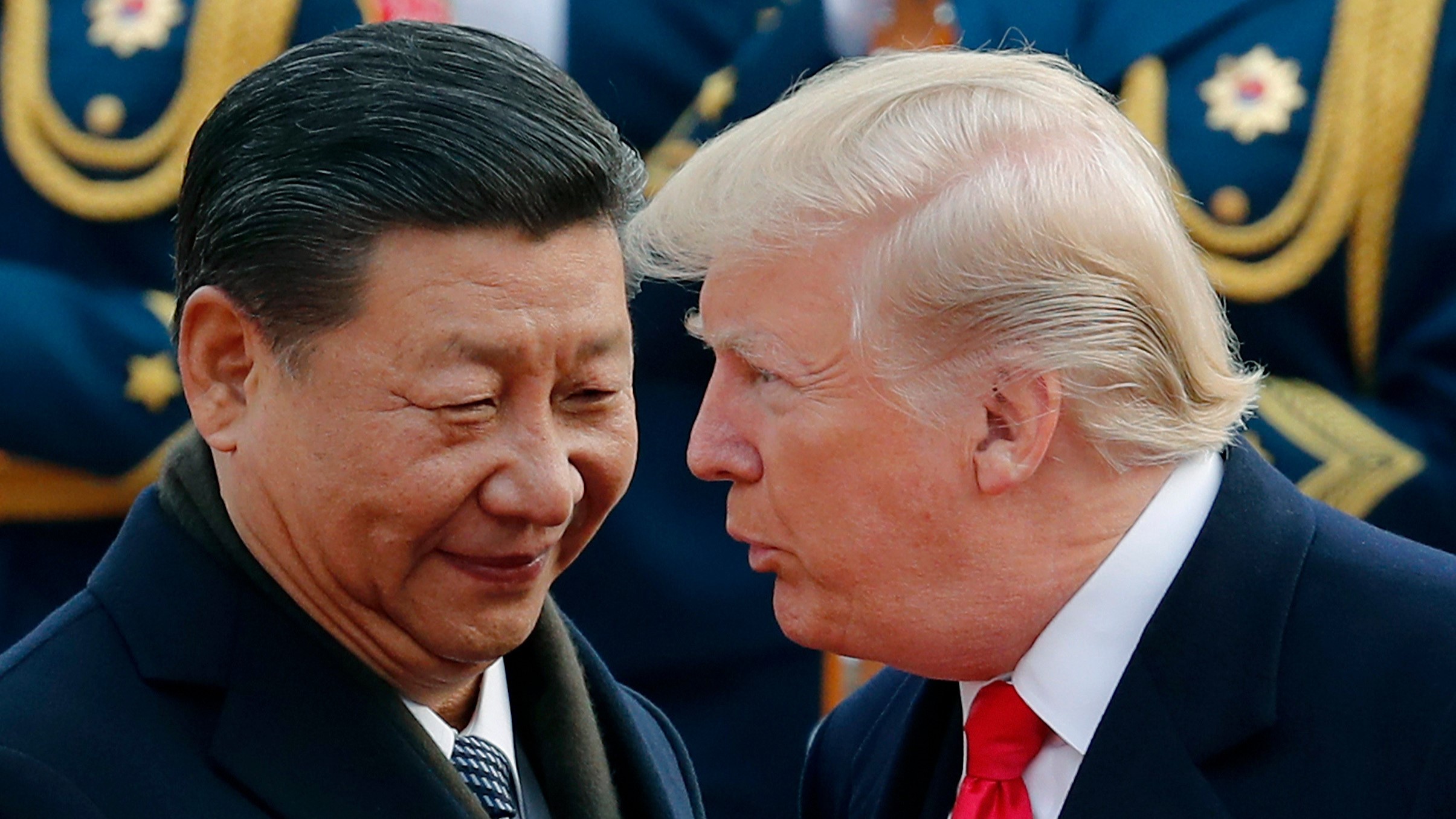 In this Nov. 9, 2017, file photo, US President Donald Trump, right, chats with Chinese President Xi Jinping during a welcome ceremony at the Great Hall of the People in Beijing.