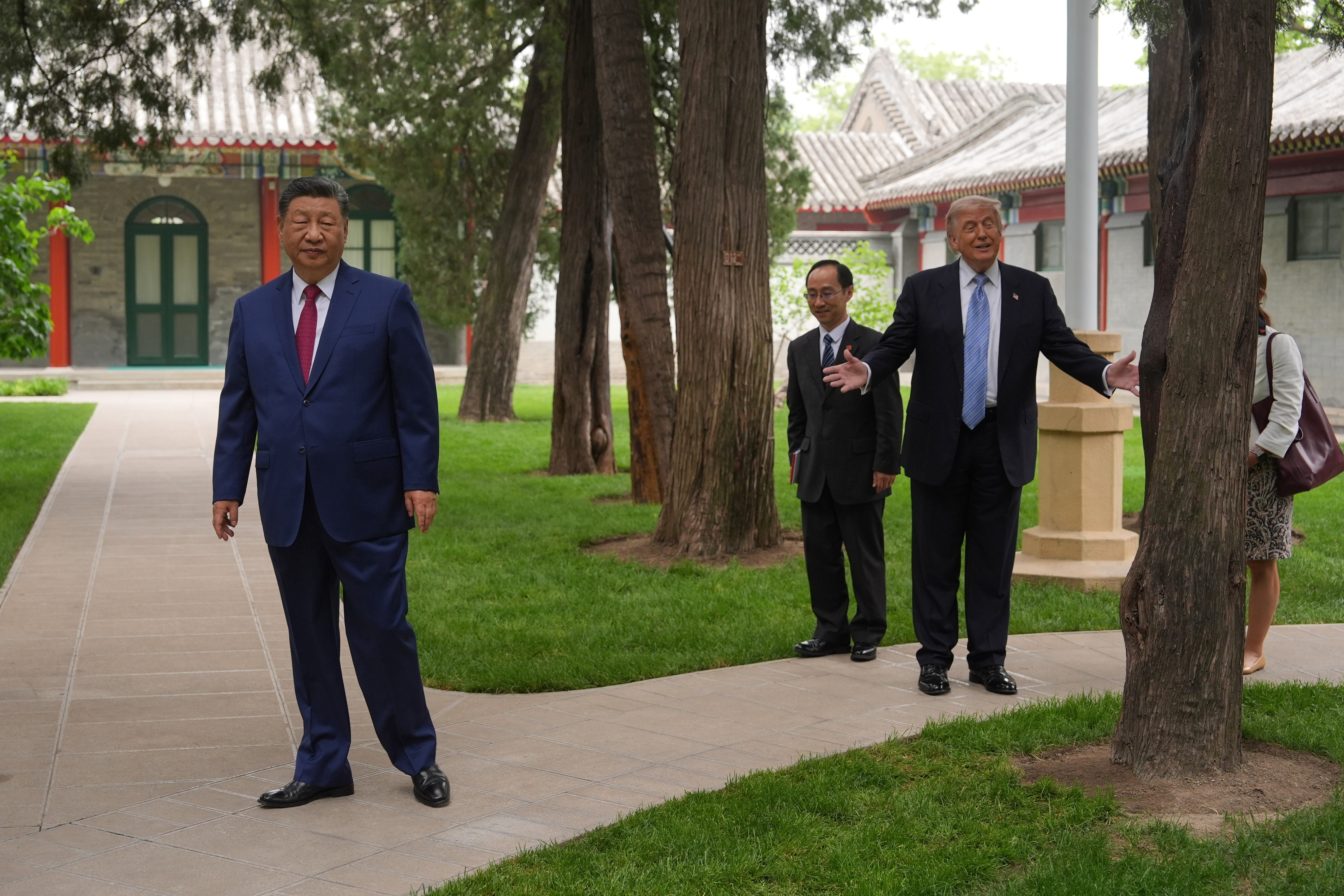 President Donald Trump walks with China's President Xi Jinping at the Zhongnanhai leadership compound, Friday, May 15, 2026, in Beijing.