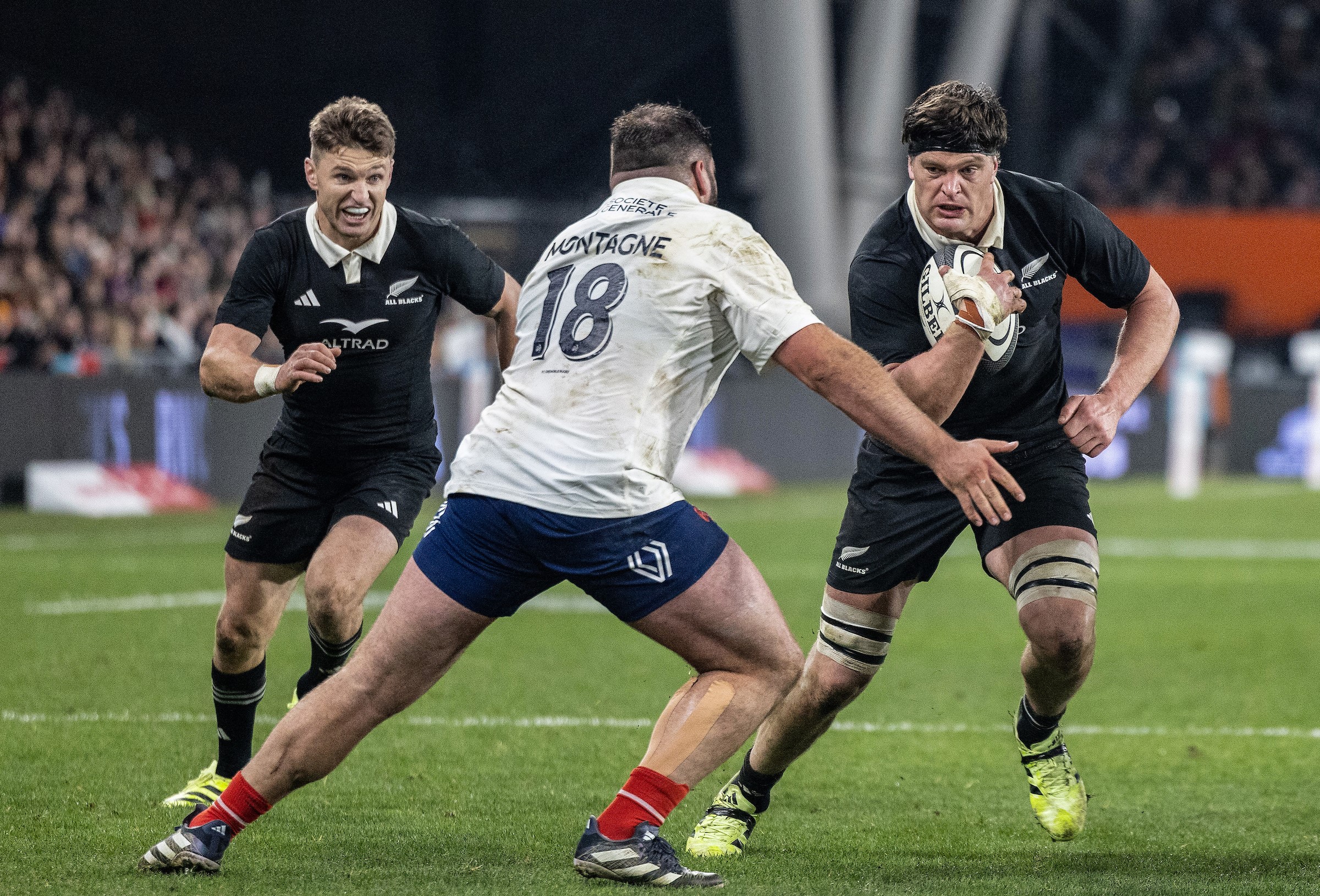 Scott Barrett carries the ball against France alongside brother Beauden.