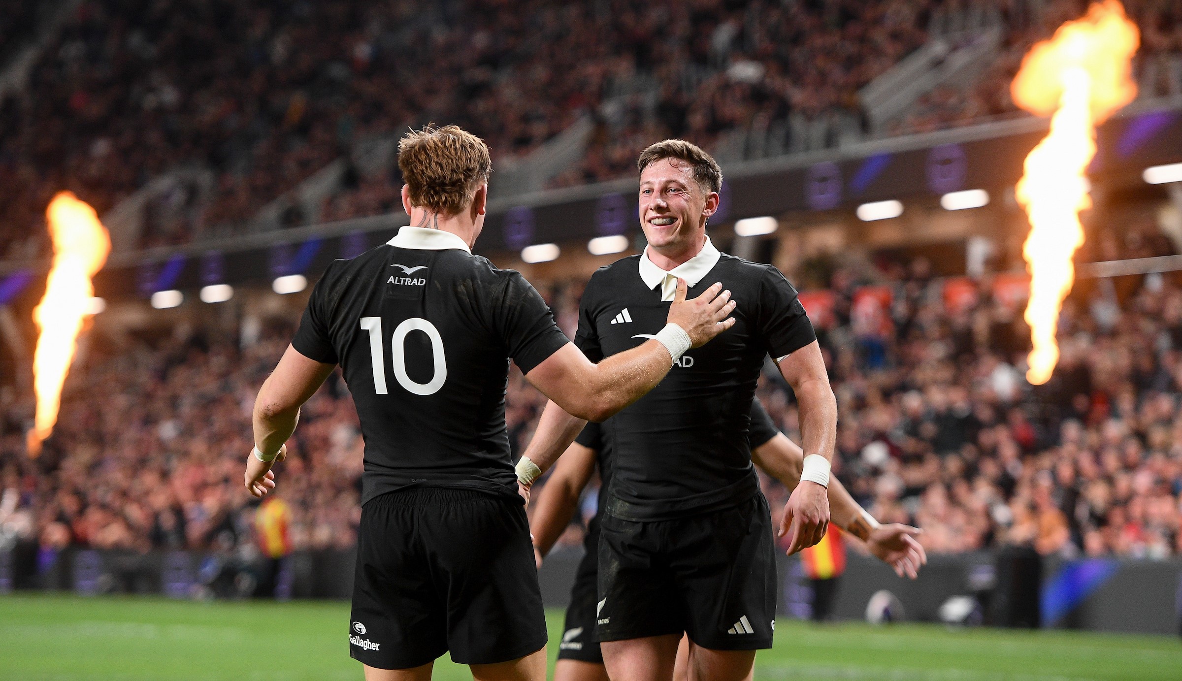 Cam Roigard celebrates his first try against France in Christchurch with Ruben Love.