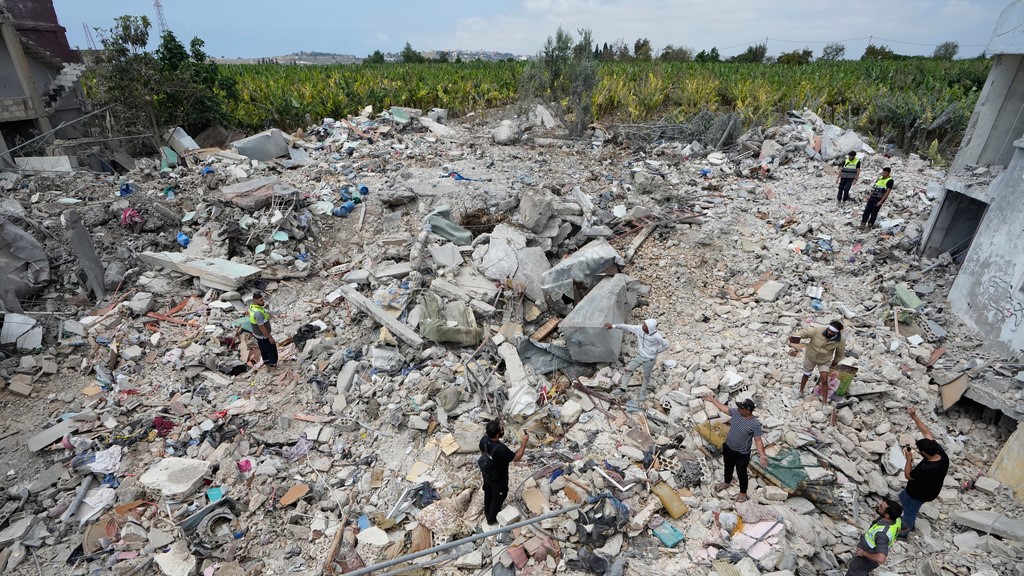 Residents and journalists inspect a building damaged in an Israeli airstrike a day earlier in the southern village of Charnay, Lebanon, Wednesday, May 27, 2026.