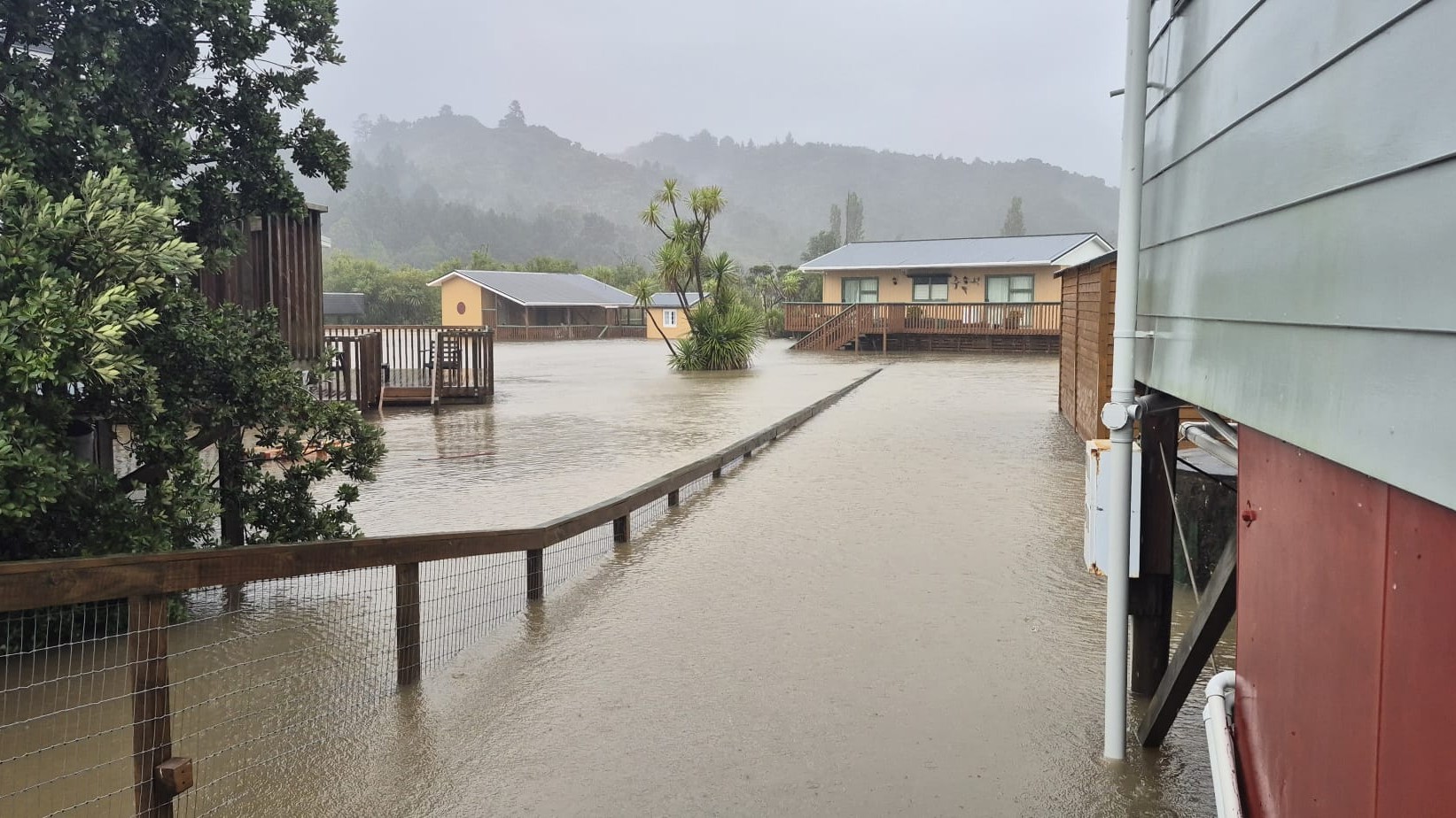 Floodwaters isolate homes in the settlement of Whiritoa, Coromandel.