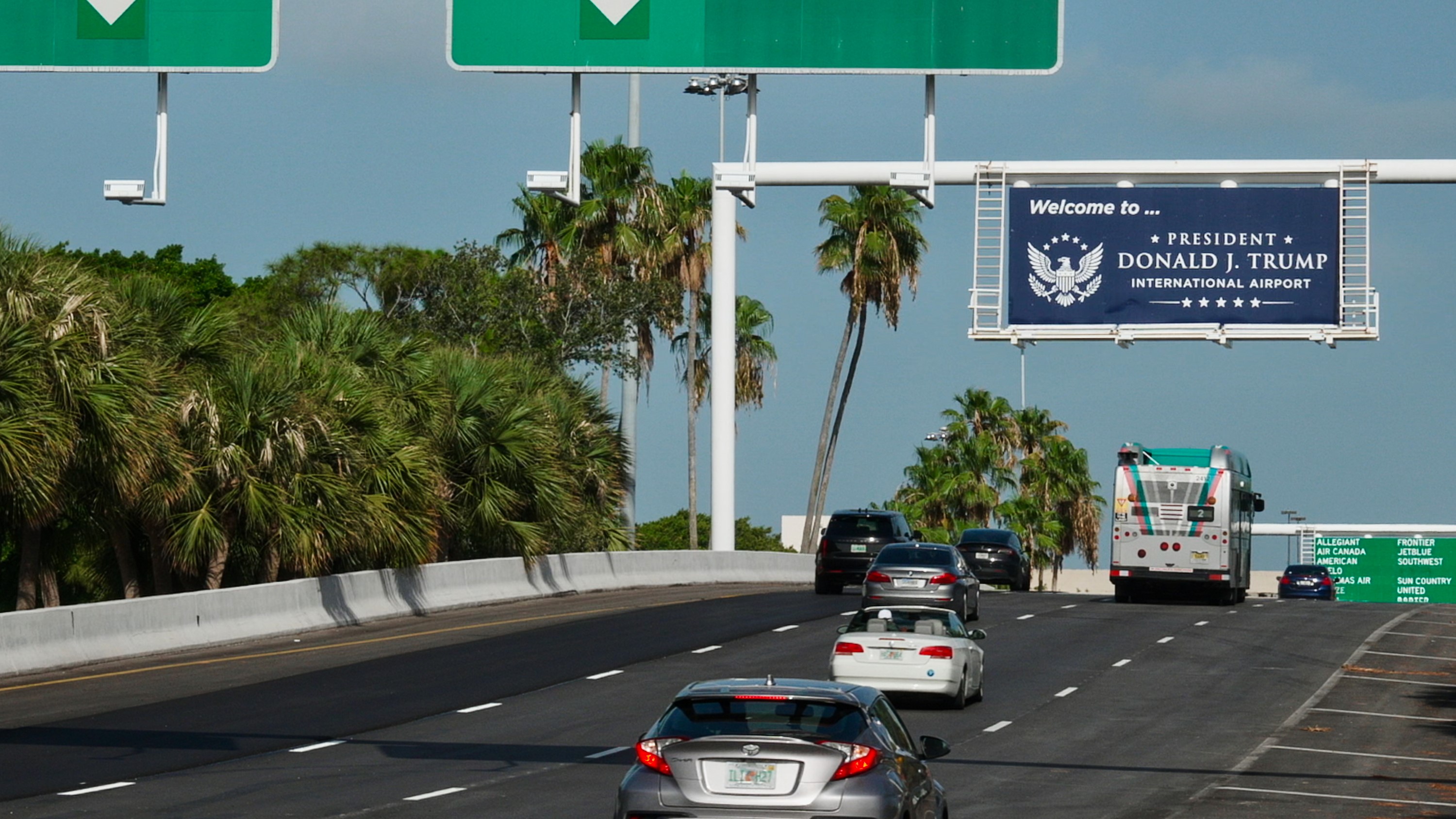 A rebranded Donald J Trump International sign over a US highway on the way to the airport.