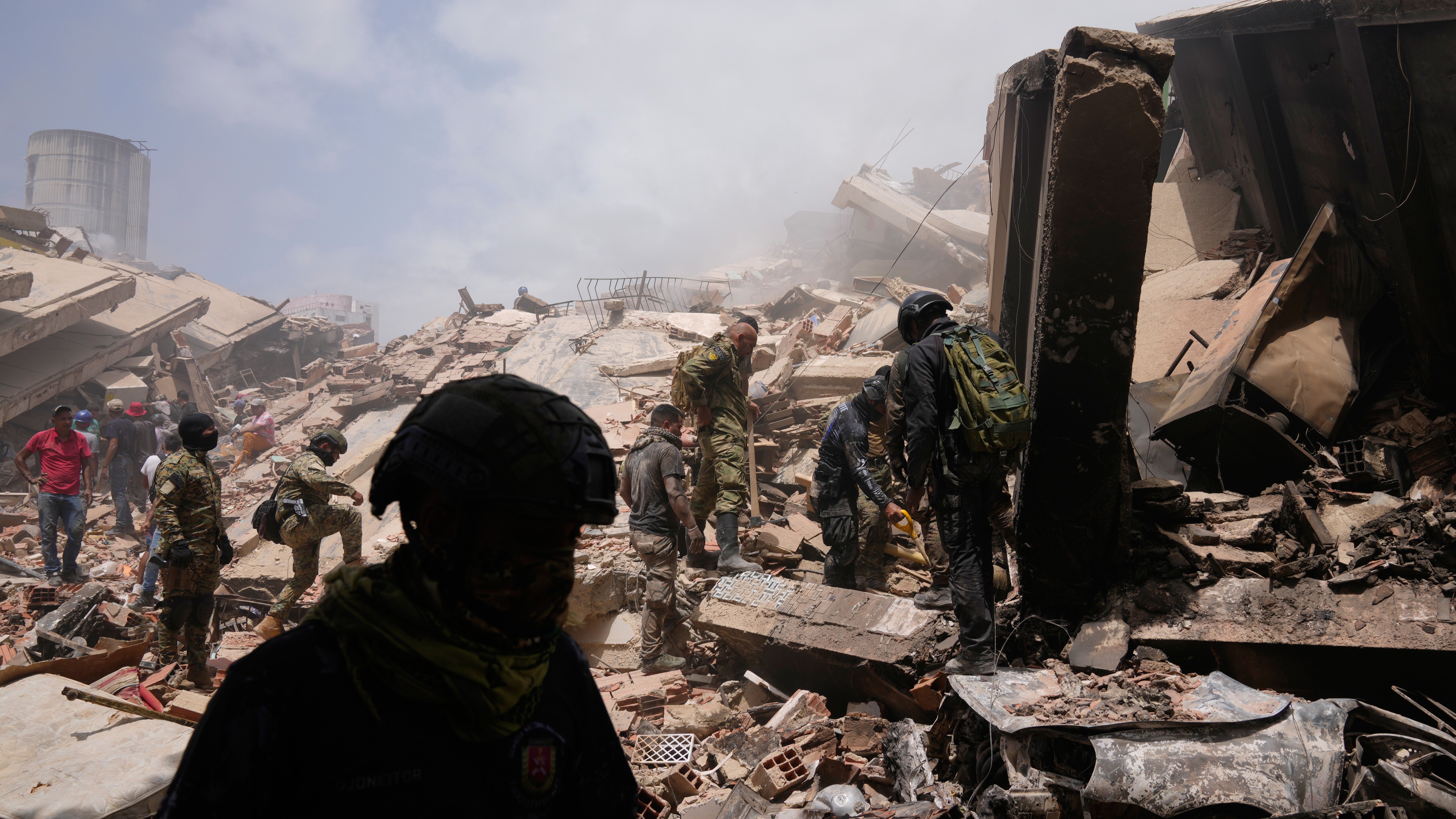 Venezuelan police search for survivors through the rubble in La Guaira, Venezuela, Friday, June 26, 2026, two days after twin earthquake struck the country.