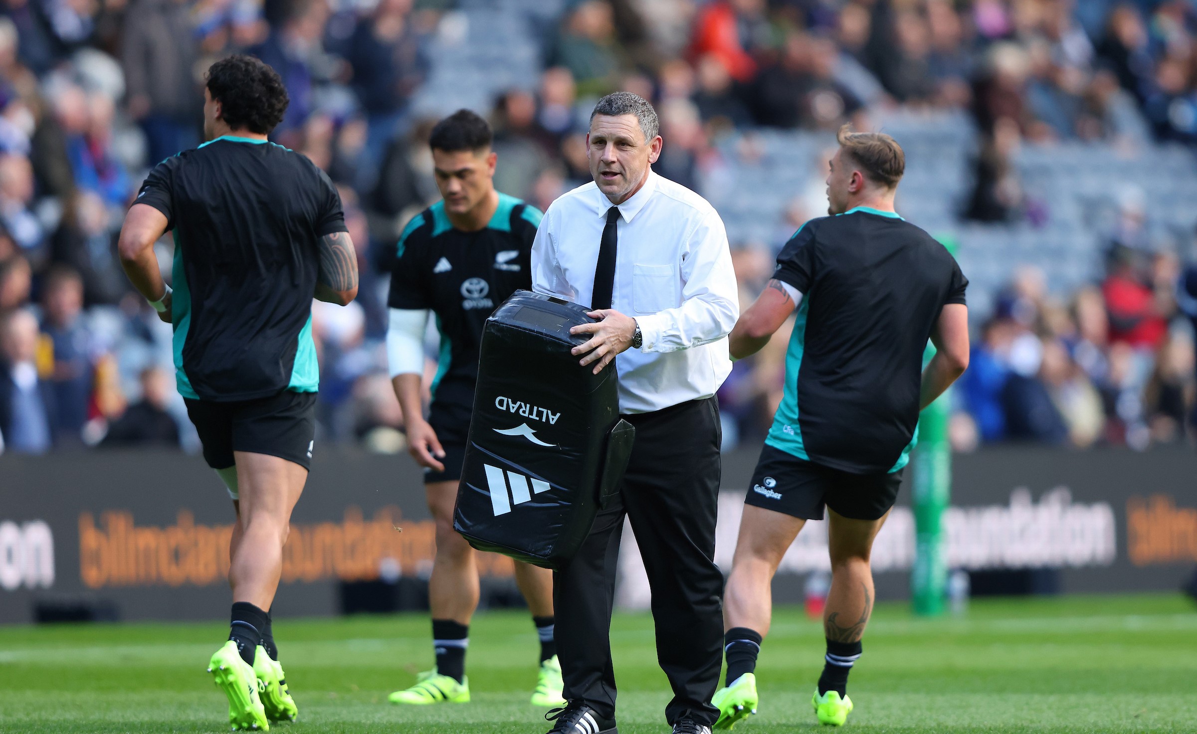All Blacks assistant coach Jason Holland helps during the team's warm-up for their win over Scotland in Edinburgh last month.