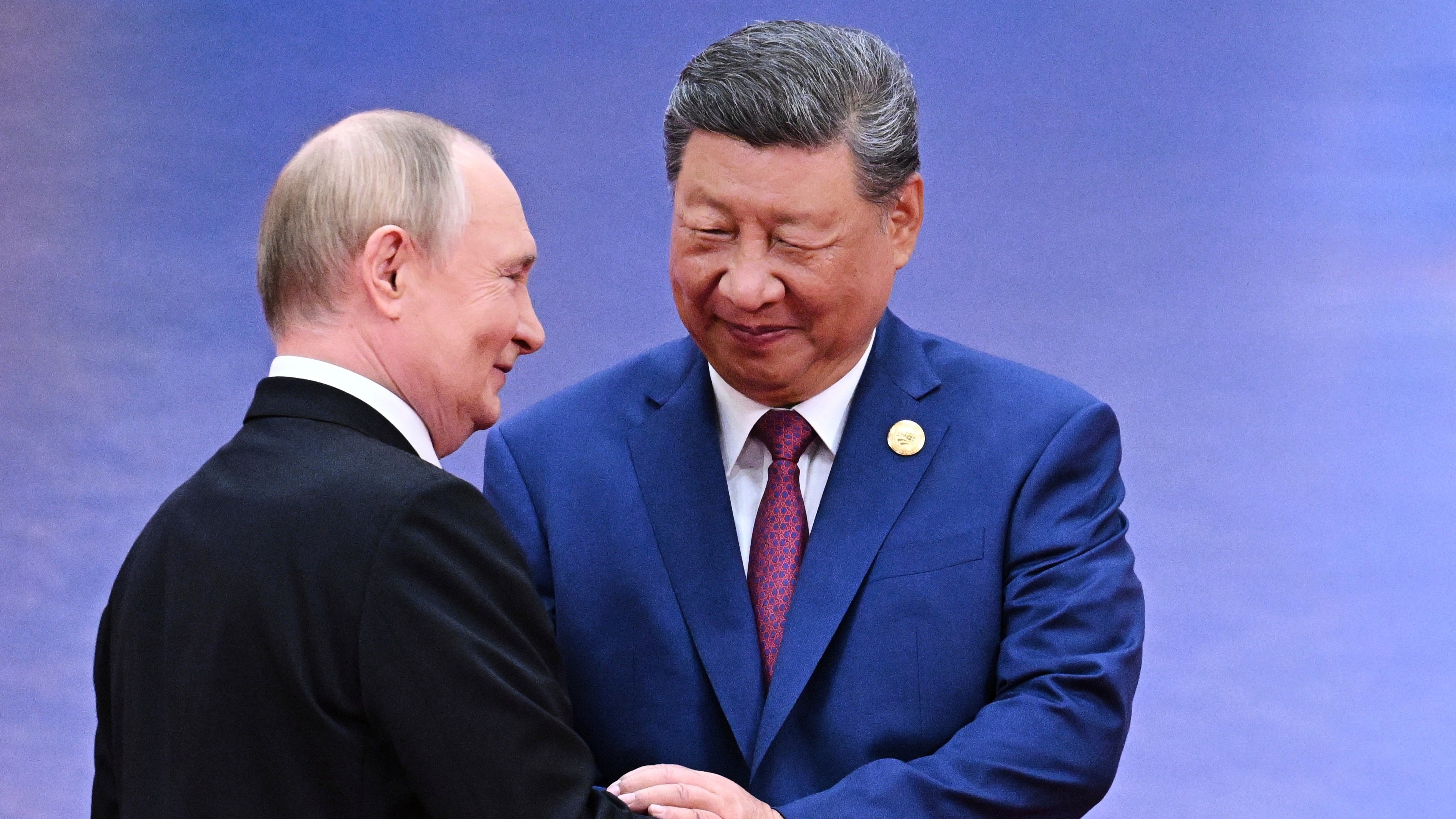 Russian President Vladimir Putin, left, and Chinese President Xi Jinping greet each other in Tianjin, China, on August 31, 2025.