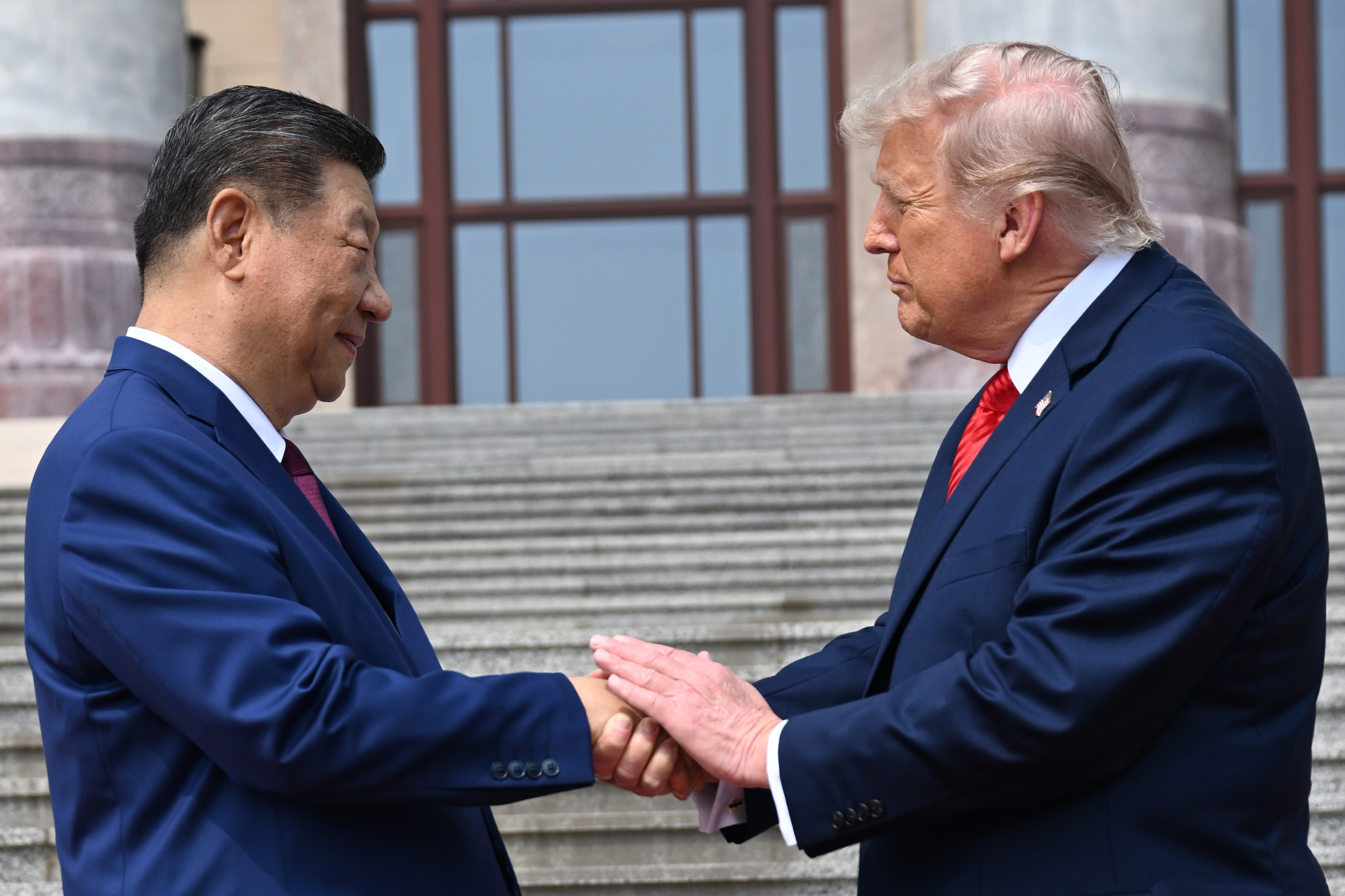 Chinese President Xi Jinping, left, shakes hands with U.S. President Donald Trump at the Great Hall of the People in Beijing, Thursday, May 14, 2026