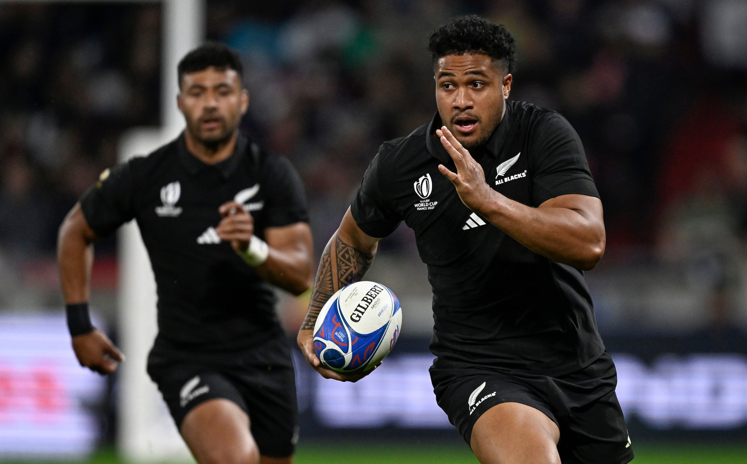 Leicester Fainga'anuku has Richie Mo'unga in support as he makes a break for the All Blacks against Uruguay during the World Cup in 2023.