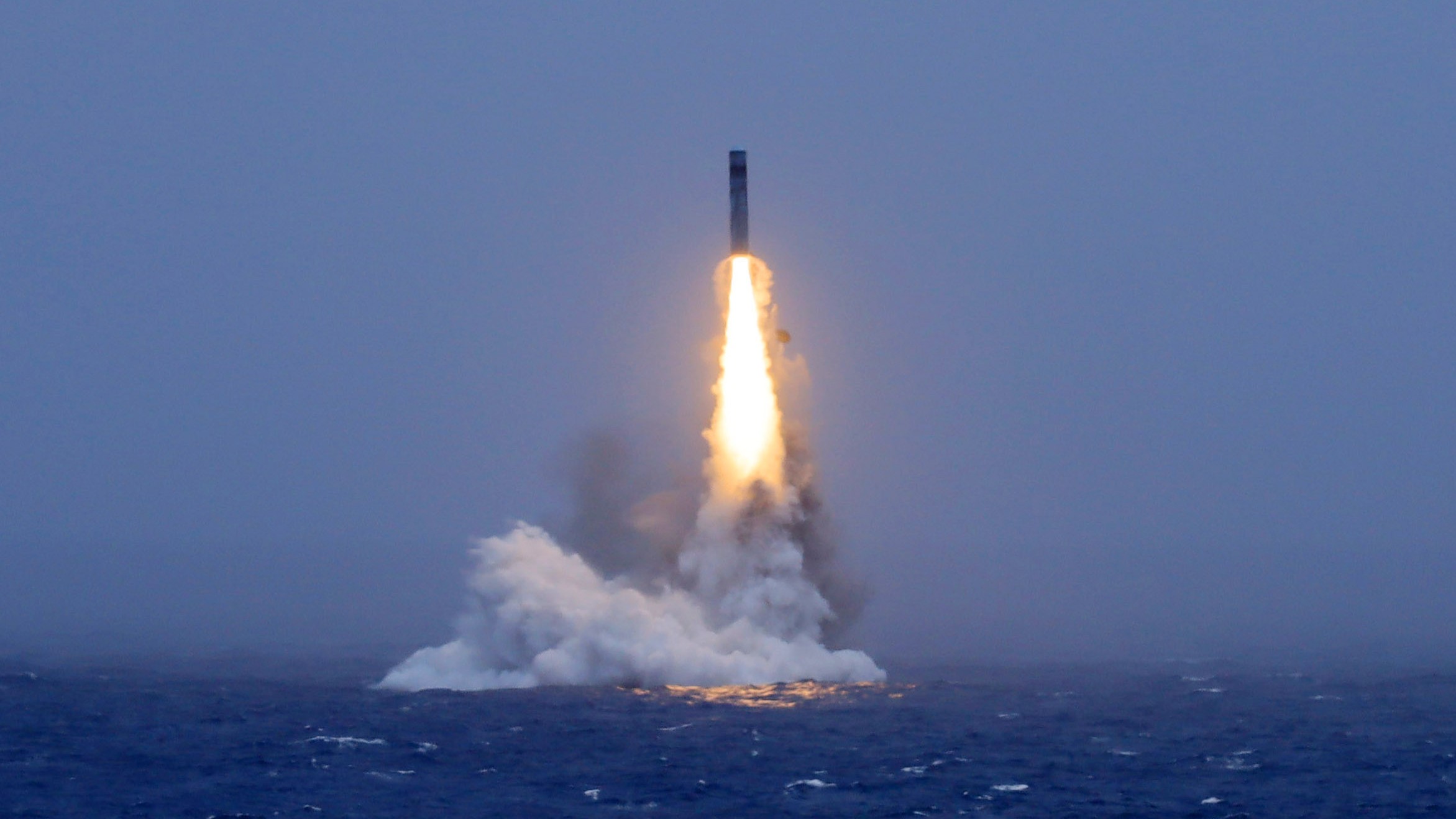 In this photo released by Xinhua News Agency, a long-range ballistic missile bursts out of the sea during a test launched from a Chinese nuclear-powered submarines in the South Pacific on Monday, July 6, 2026.