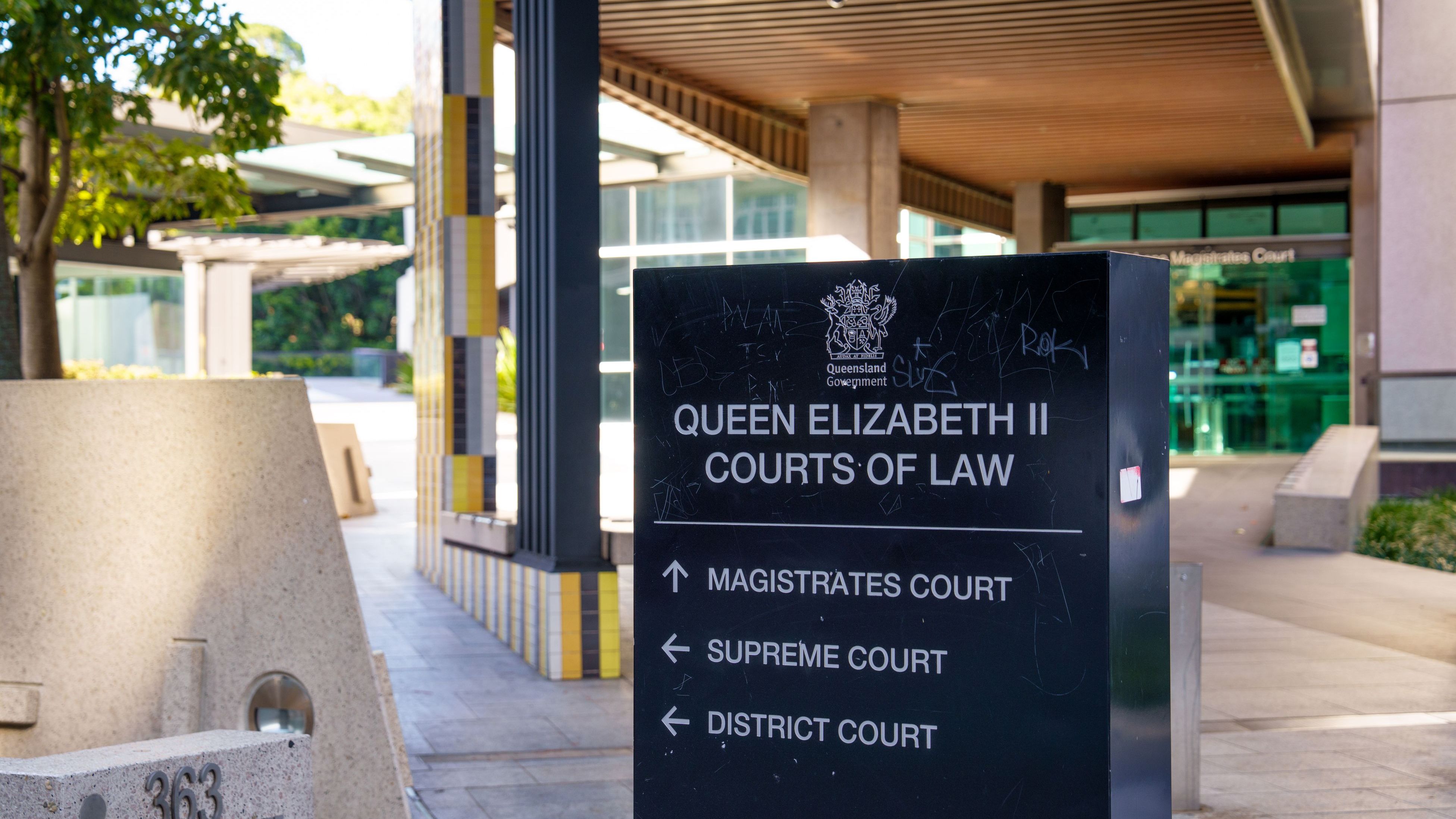 Close up of a sign with directions towards the Magistrates Court, Supreme Court and District Court
