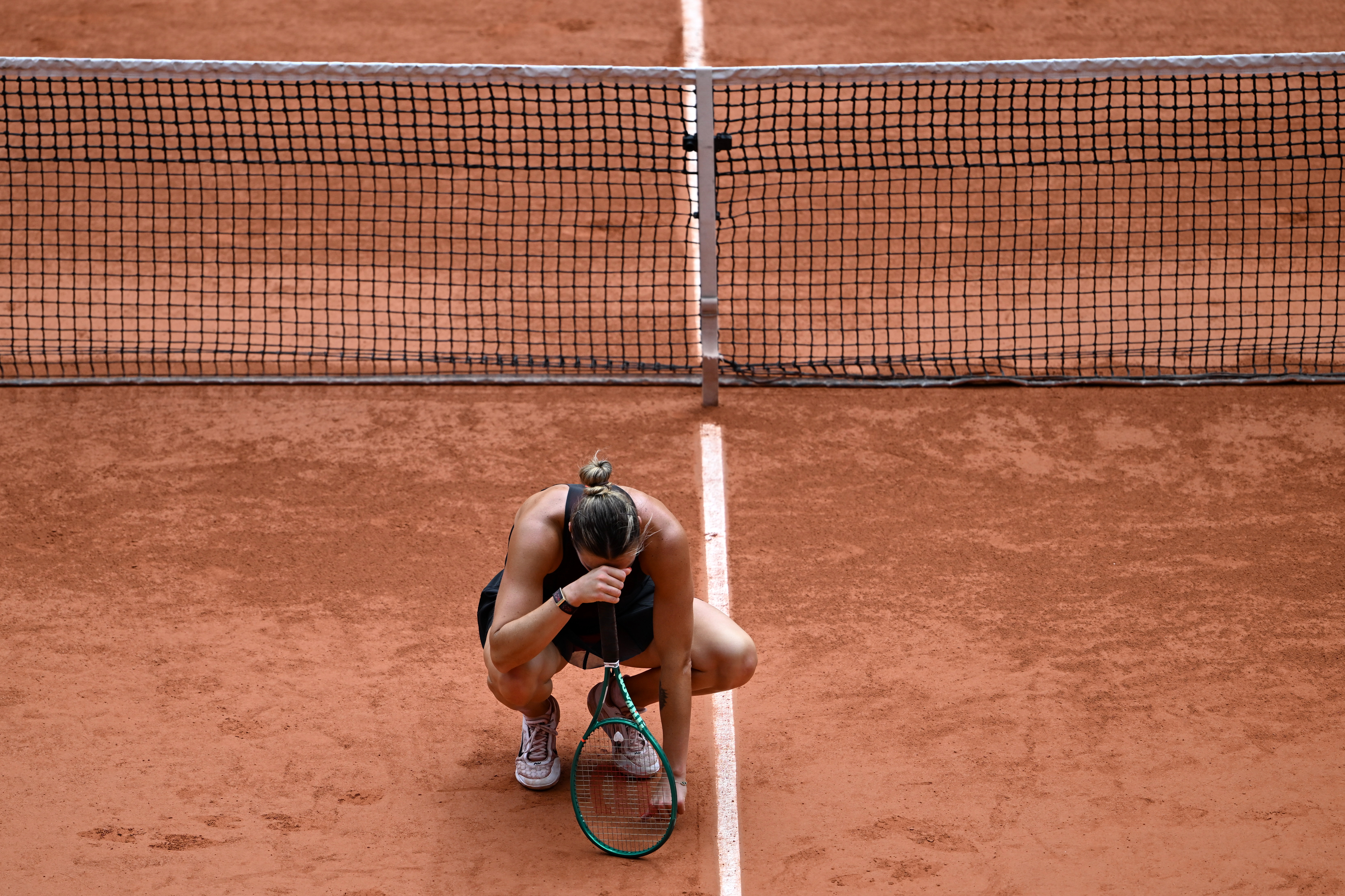 Aryna Sabalenka of Belarus reacts after losing the quarterfinal tennis match against Russia's Diana Shnaider at the French Open in Paris