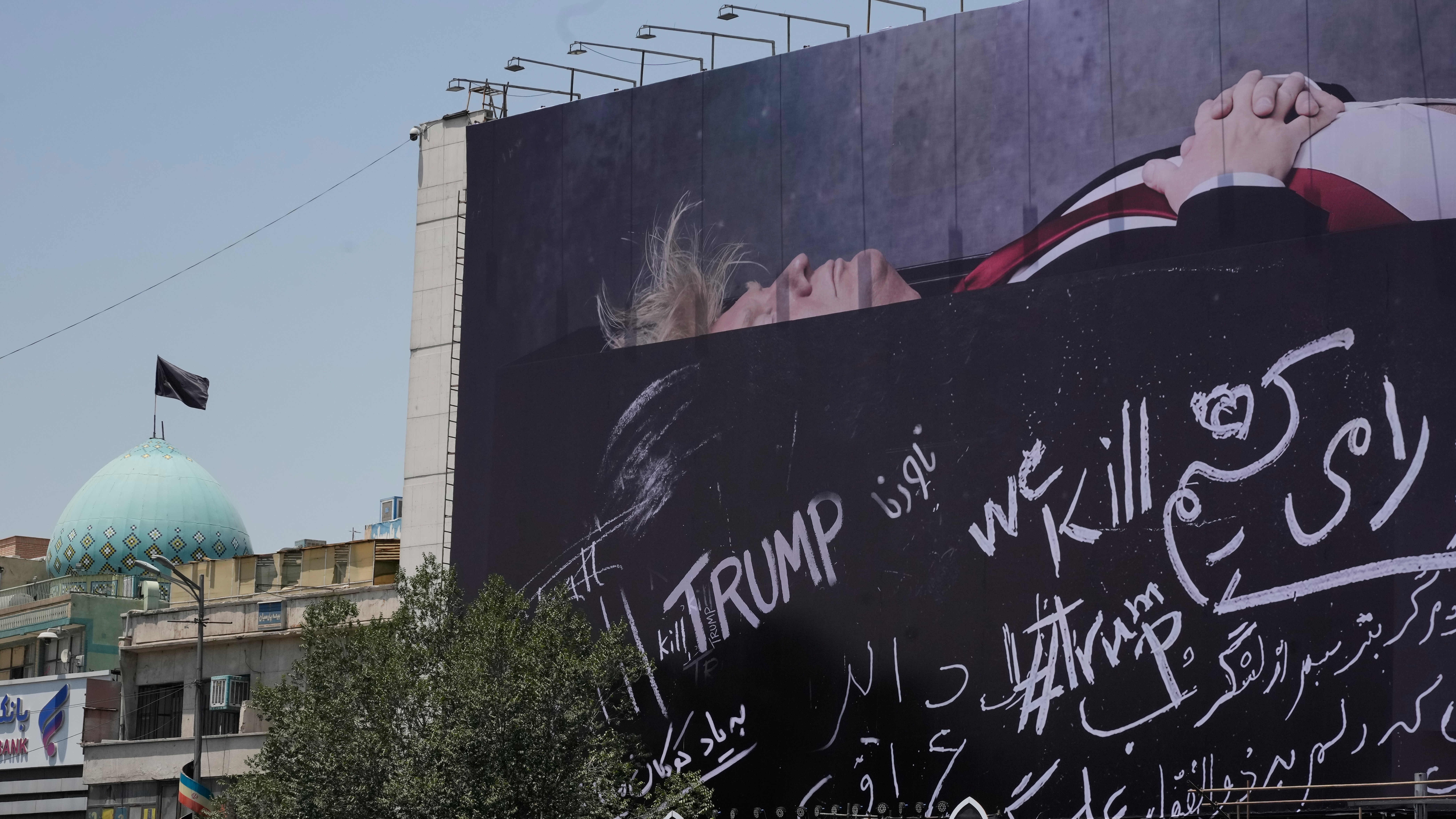 A billboard depicting US President Donald Trump lying on what appears to be a coffin at Islamic Revolution Square in downtown Tehran.