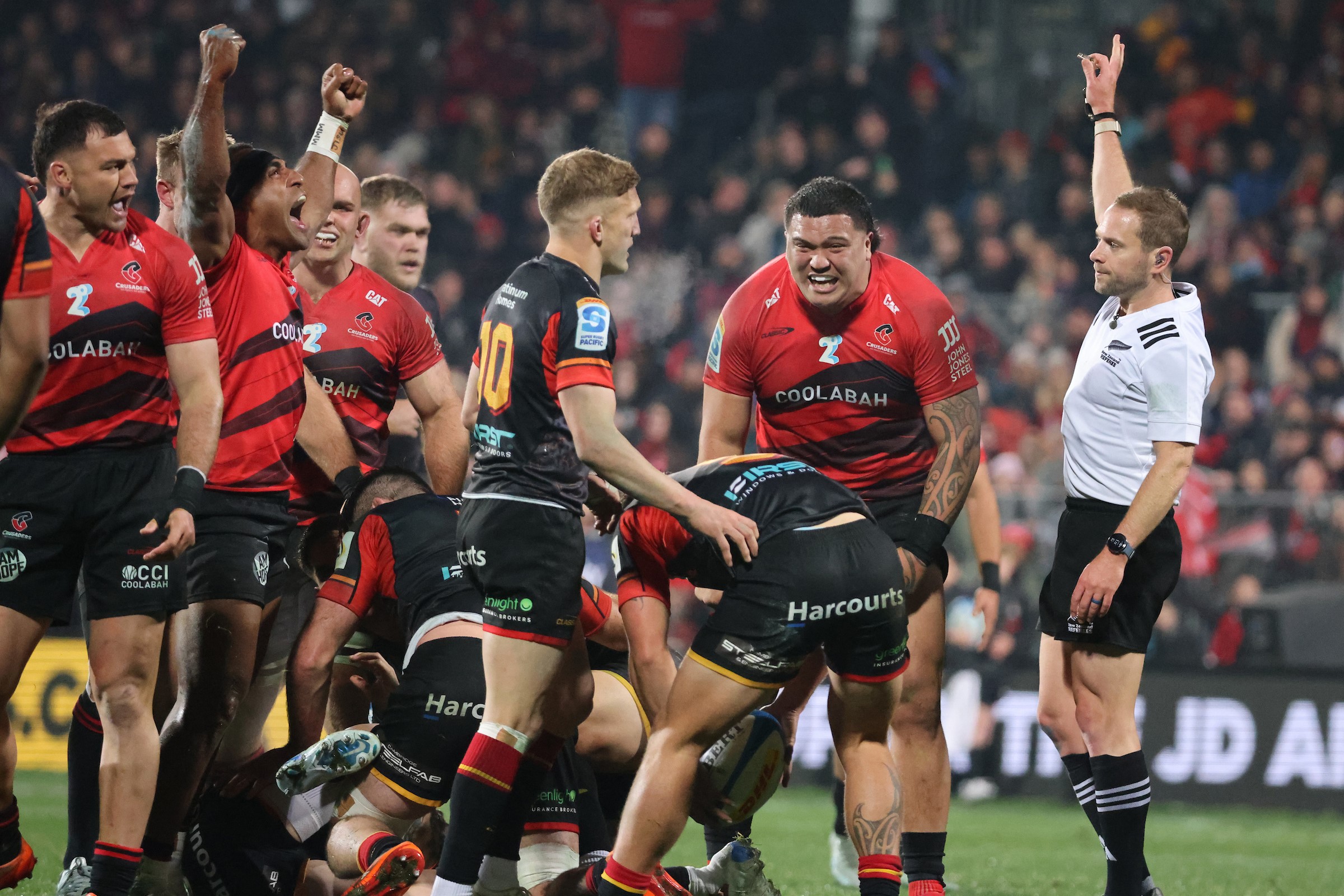 The Crusaders celebrate a penalty awarded by ref Angus Gardiner against the Chiefs.