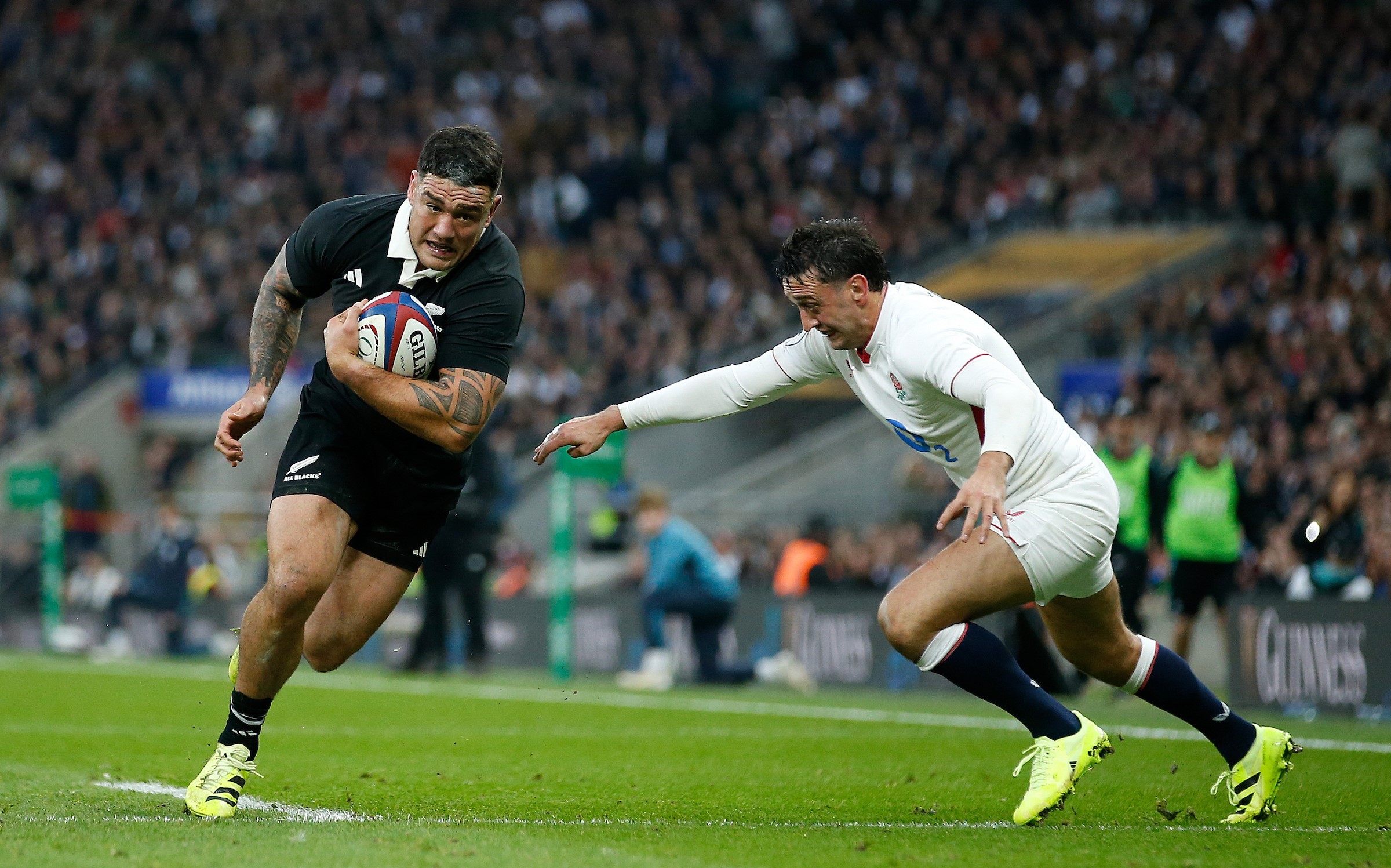 Codie Taylor beats Alex Mitchell on the way to scoring a try in the All Blacks' defeat to England at Twickenham last November.