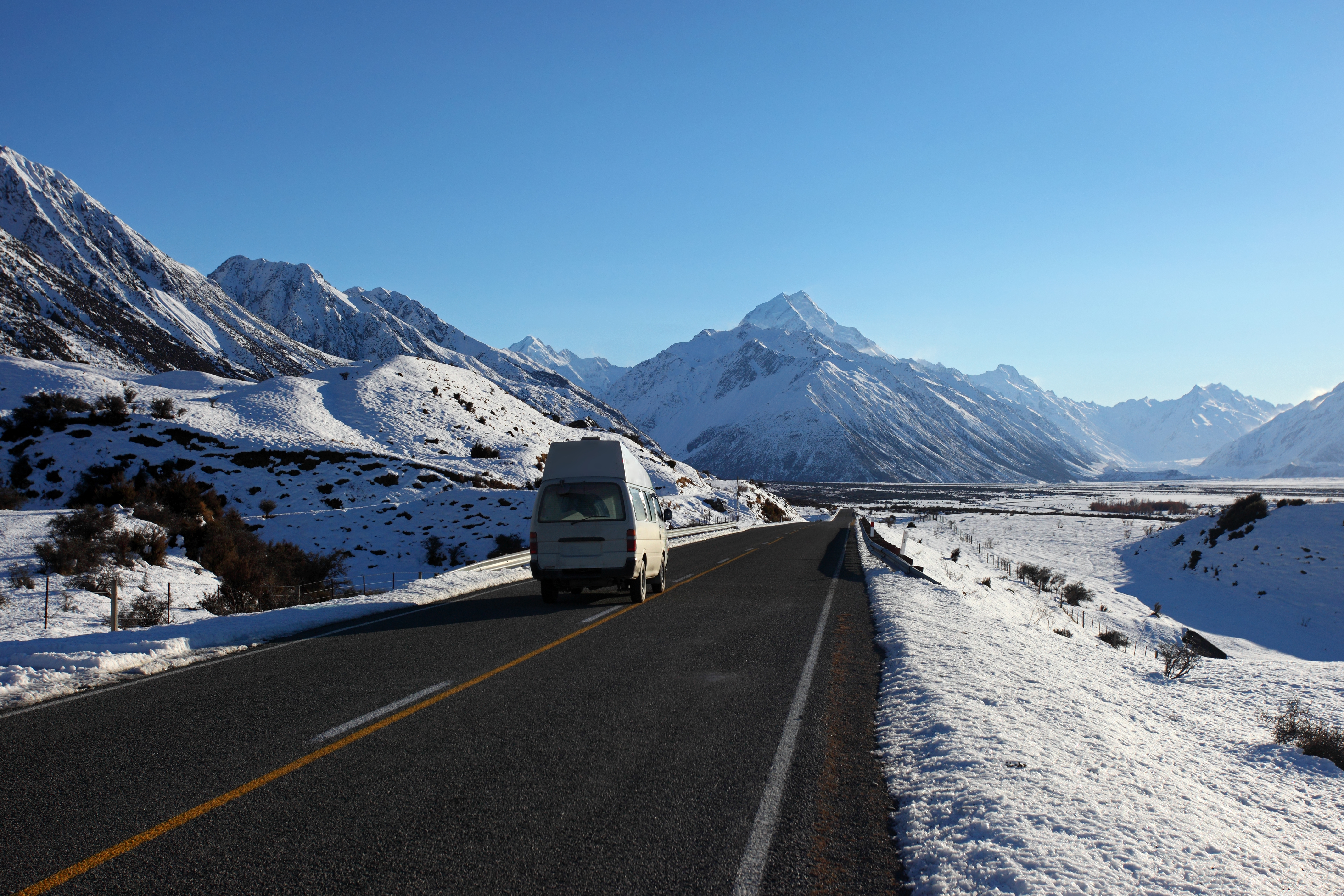 A caravan drives along the highway near Aoraki Mt Cook. 
