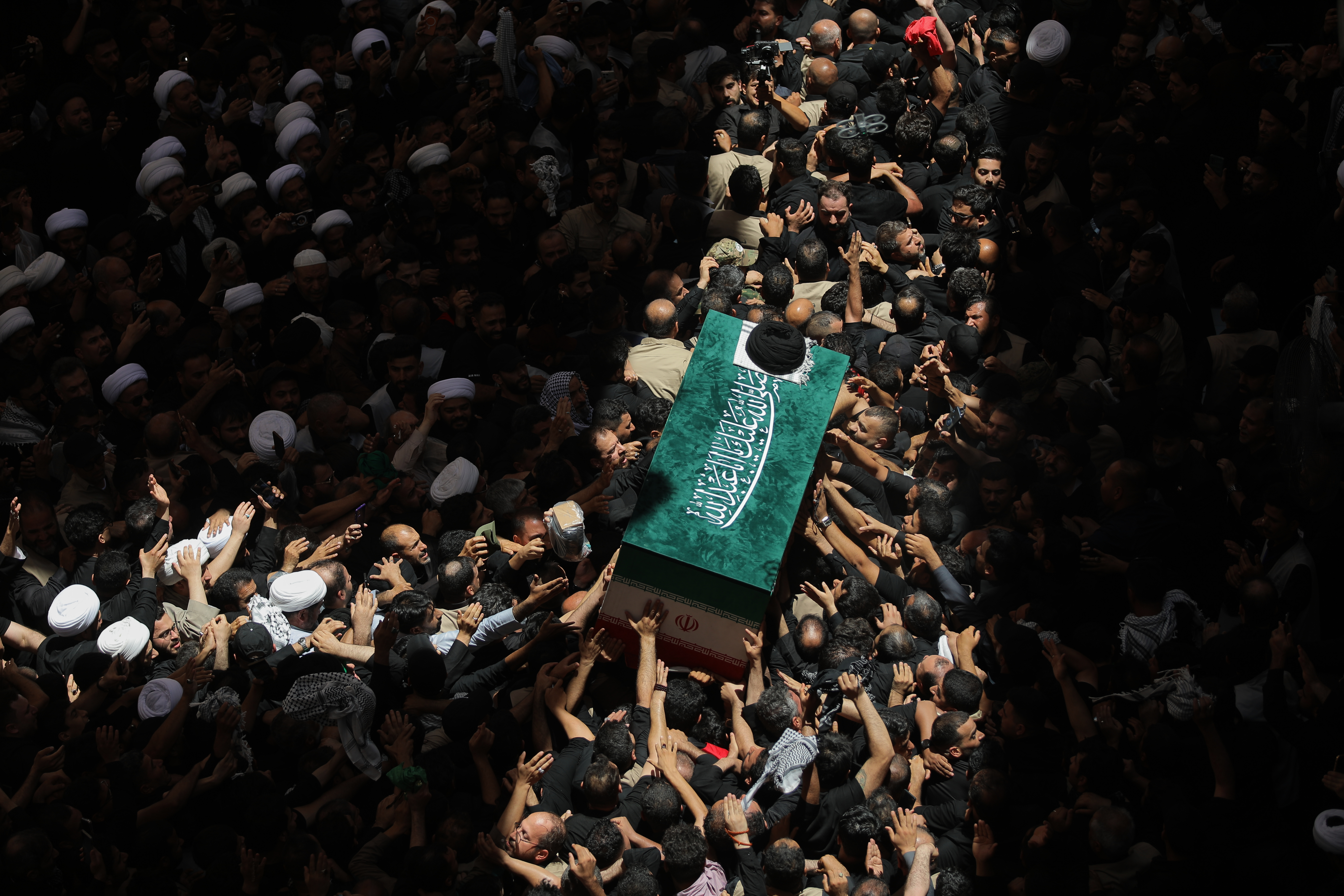 The coffin of the late Iranian Supreme Leader Ayatollah Ali Khamenei is carried by mourners to the Imam Ali Shrine in Najaf, Iraq, Wednesday, July 8, 2026.