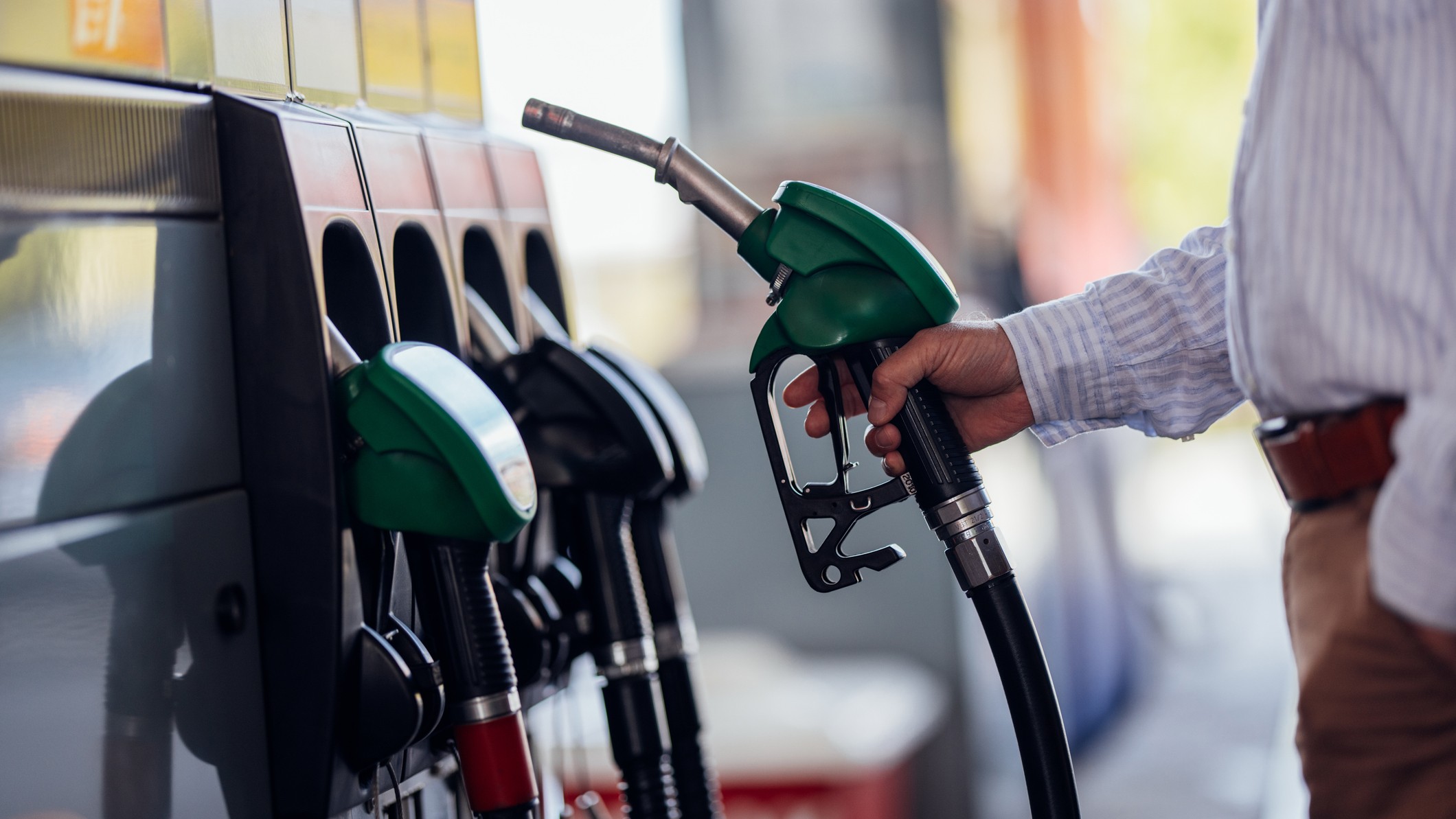 Close-Up of Man Refueling Vehicle at Gas Station Pump. File photo.