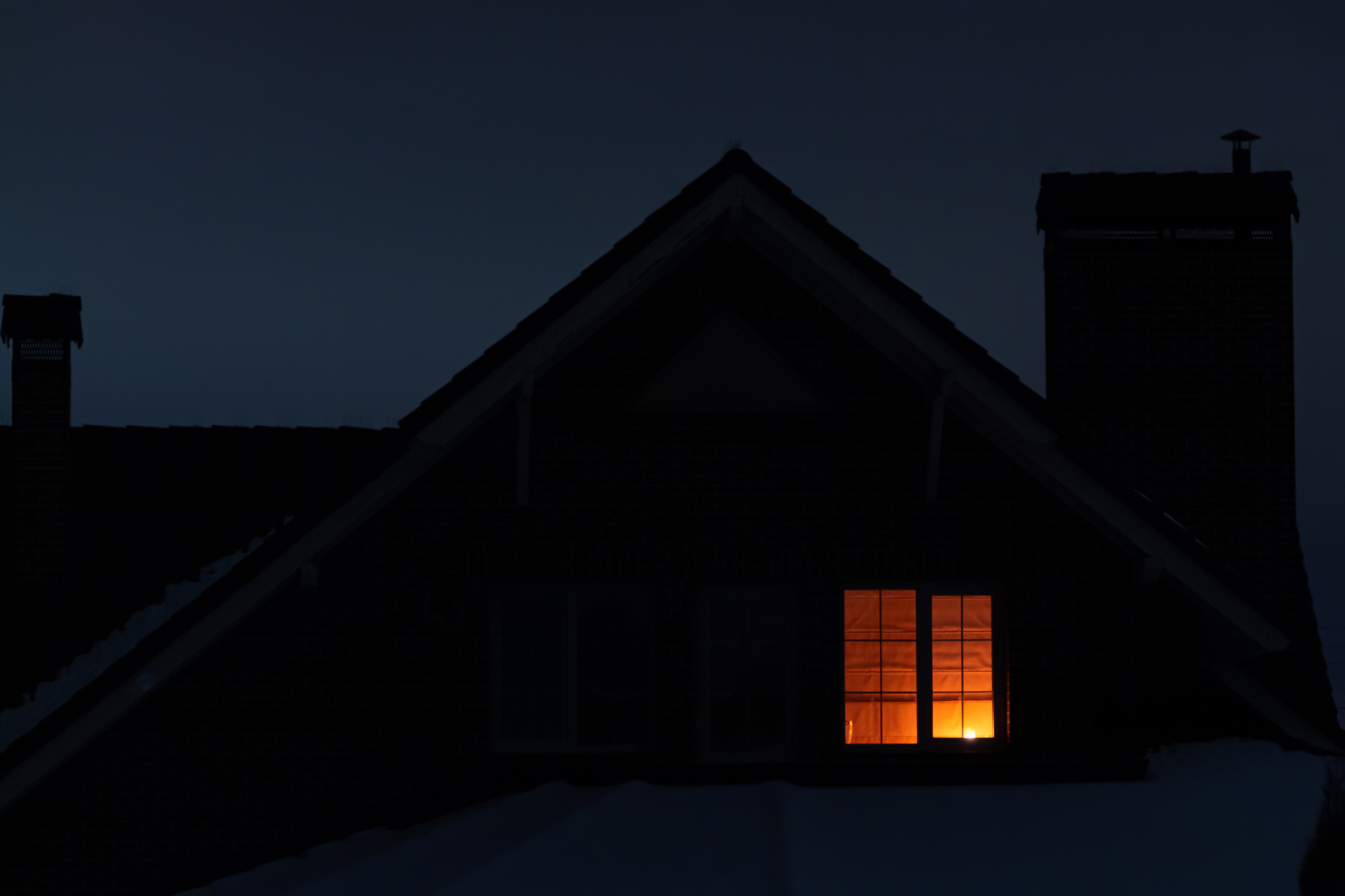 A house with a light on inside.